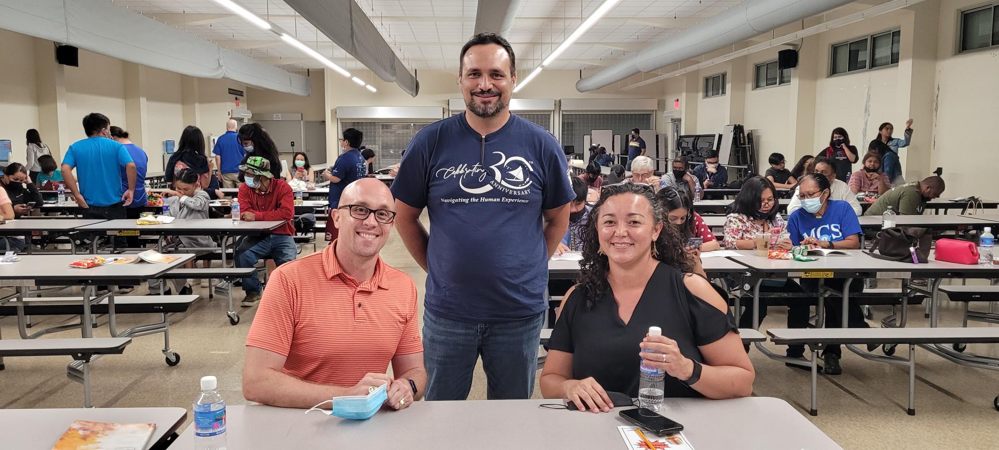 Recital judges Adam Walsh and Rep. Leila Staffer pose for a photo with Humanities Council executive director Leo Pangelinan.