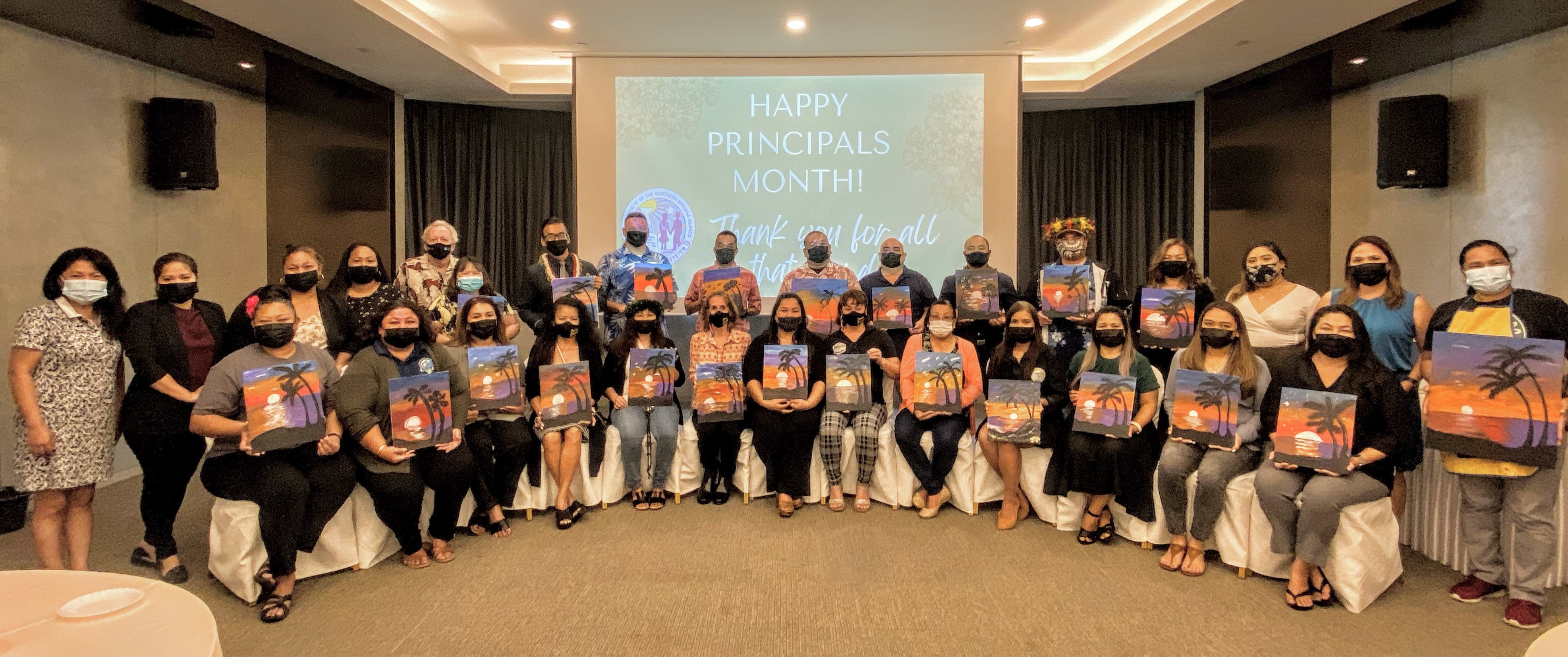 Local artist Linda Torres, extreme right, with Principals Raena Camacho (Gregorio T. Camacho Elementary School); Derwin Johnson (Garapan Elementary School); Jasylene Parico (Oleai Elementary School); Lynn Mendiola (William S. Reyes Elementary School); Naomi Nishimura (Koblerville Elementary School); Paulette Tomokane (San Vicente Elementary School); Dr. Ignacia Demapan (Kagman Elementary School); Lou Connie Manglona (Tinian Elementary School); Daisy Quitugua (Sinapalo Elementary School); Hilda Rios (Tanapag Middle School), Victor Borja (Hopwood Middle School); Cherlyn Osung (Francisco M. Sablan Middle School); James Sablan (Dandan Middle School); Martha Kintol (Chacha Oceanview Middle School), Jonathan Aguon (Marianas High School); Vince Dela Cruz (Saipan Southern High School); Benjamin Jones (Kagman High School); Christine Tudela (Da’ok Academy);  Liz Hofschneider (Tinian Jr. Sr. High School), and D. Tanya King (Dr. Rita H. Inos Jr. Sr. High School). Also in photo are acting Commissioner of Education Eric Magofna and other members of the PSS leadership team.