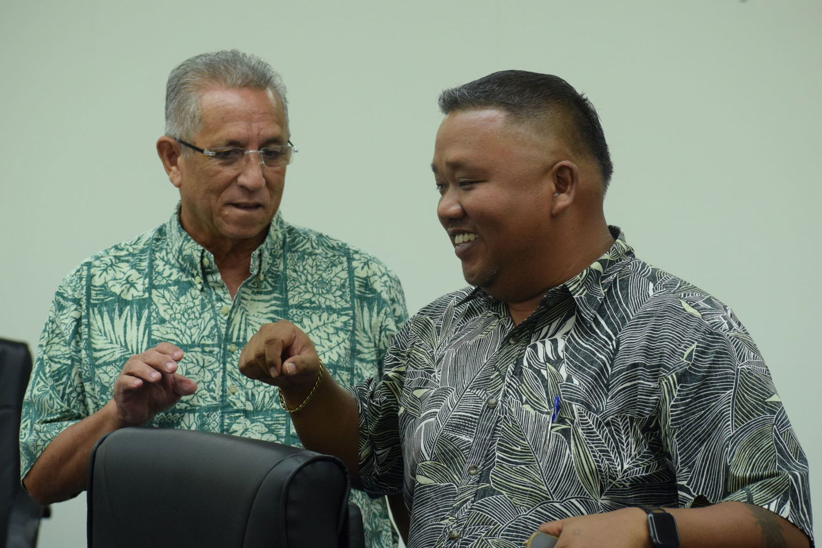 House Minority Leader Angel A. Demapan, right, listens to Rep. Joseph Leepan T. Guerrero during a break from Friday's House session.