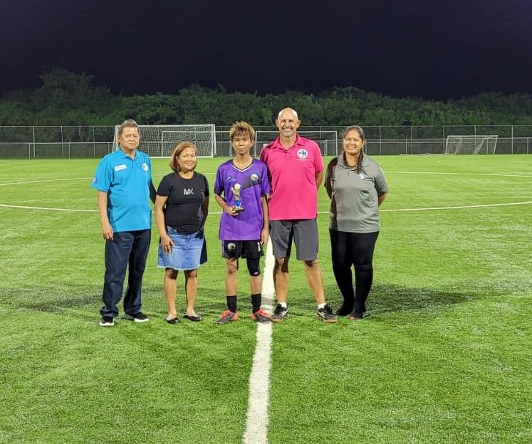 Hopwood's Mark Costales poses with the Golden Boot Award with NMI Football Association's Ross Zapanta, NMIFA’s Elna Curate, PSS Athletic Director Nick Gross and NMIFA's Catherine Attao-Toves during Friday's awards ceremony at the NMI Soccer Training Center.