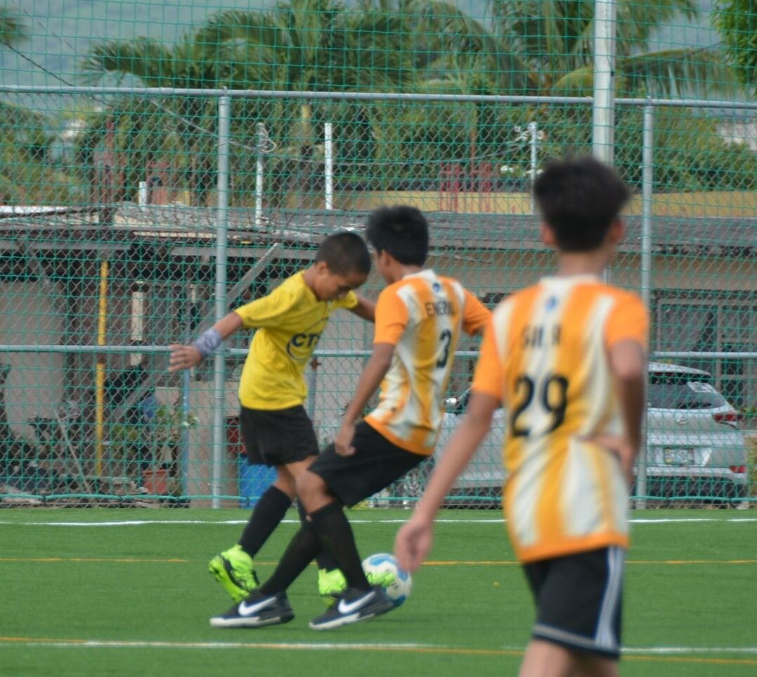 Matansa’s Anton Megino attempts to slip past a defender during a U12 division game of the Youth League Fall Tournament Saturday at the NMI Soccer Training Center.