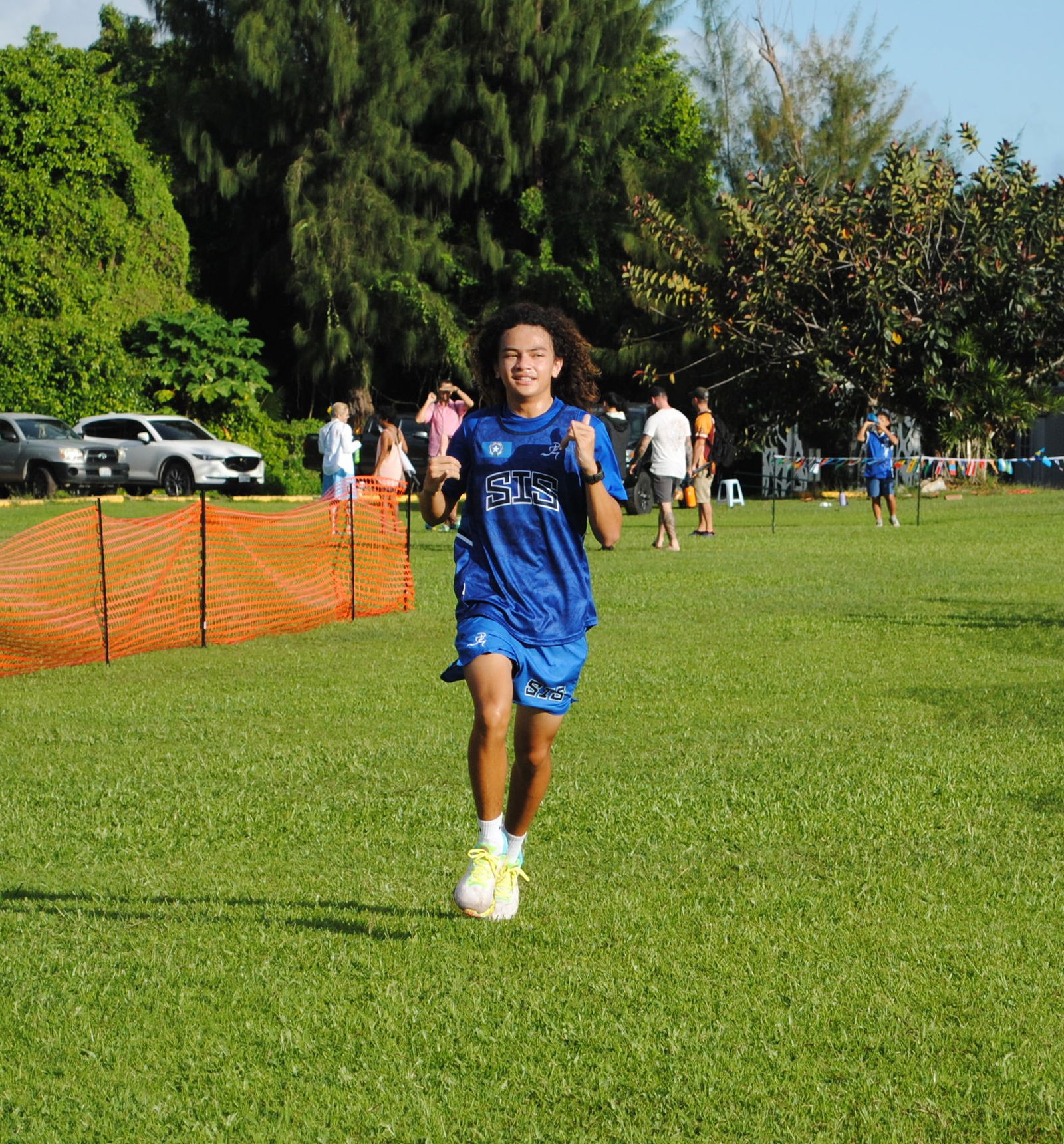 Saipan International School’s Rex Pixley smiles as he crosses the finish line in first place in the third qualifier of the PSS-NMA Cross Country series at the Saipan Vegas Country Club on Saturday.