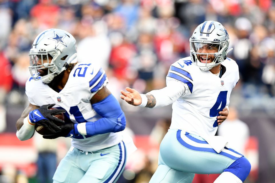 Dallas Cowboys quarterback Dak Prescott (4) hands the ball off to running back Ezekiel Elliott (21) during the first half of a game against the New England Patriots at Gillette Stadium in Foxborough, Massachusetts on Sunday.