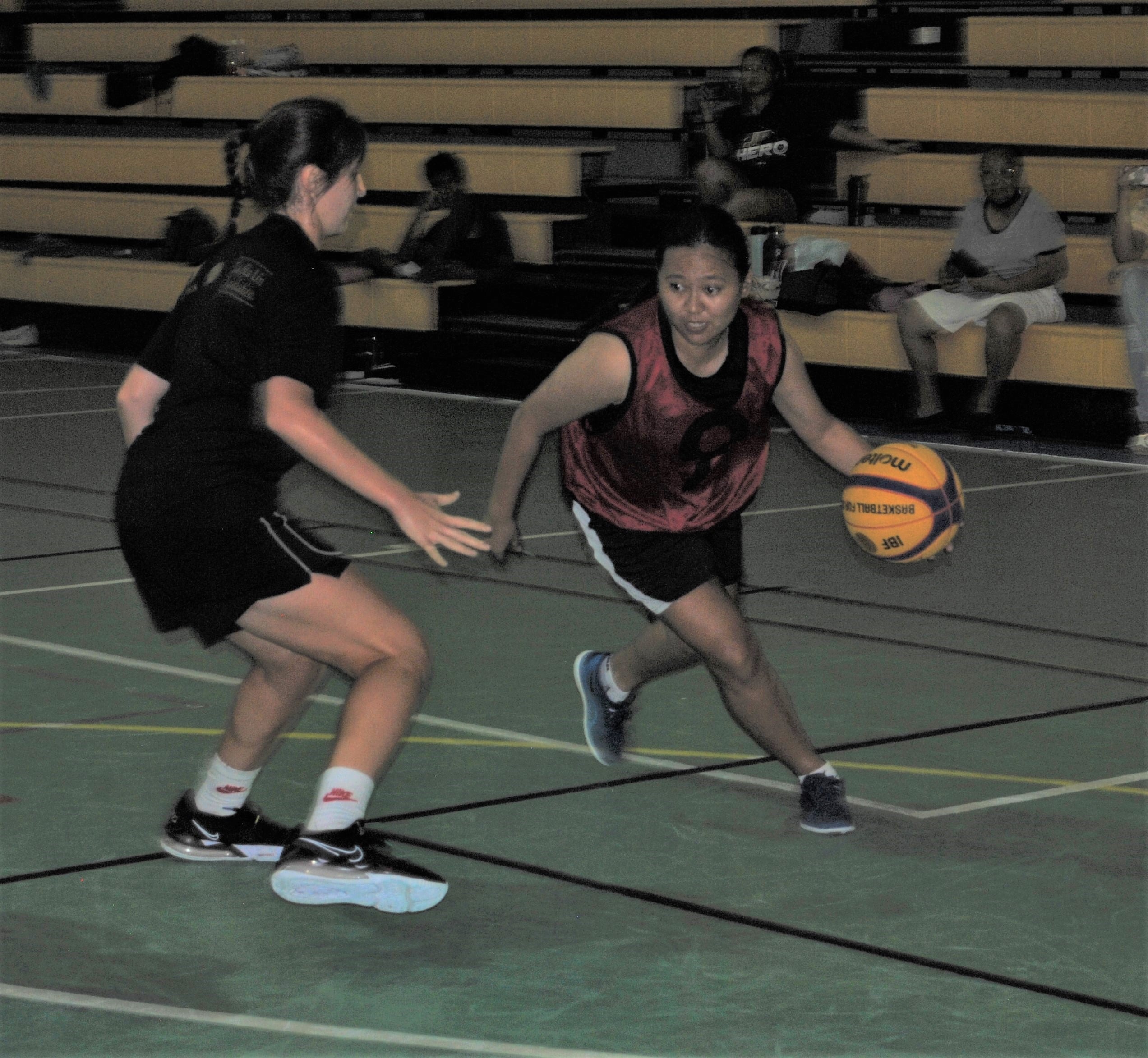 Bellaballs' Jeraldine Castillo attempts to dribble past SHAMMII's Gabi Race.