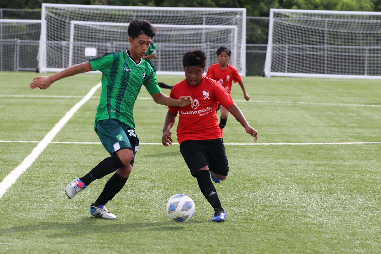 Paire’s Aidi Danis races against a TanHoldings player for the possession during the opening game of the U12 Youth League Fall 2021 Tournament on Saturday at the NMI Soccer Training Center’s mini-pitch.