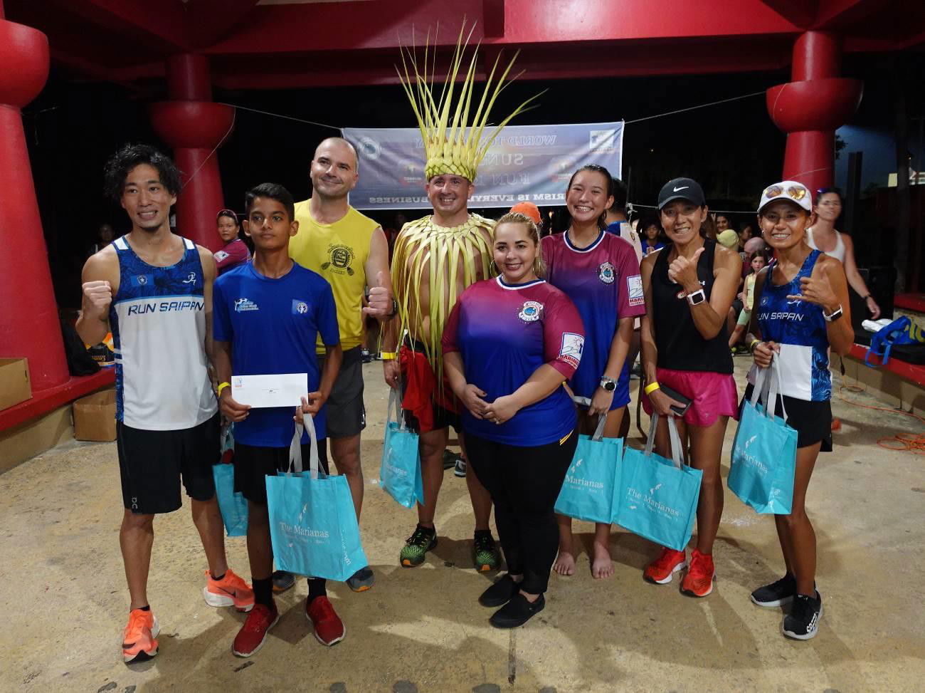 Marianas Visitors Authority Managing Director Priscilla Maratita Iakopo awards winners of the World Tourism Day Sunset Fun Run in Susupe, Saipan on Sept. 27, 2021.  From left, Shuji Kuroda, Dev Bachani, Tomas Abel, Brad Ruszala, Iakopo, Akiko Miller, Tiana Cabrera, and Lydia Tan.