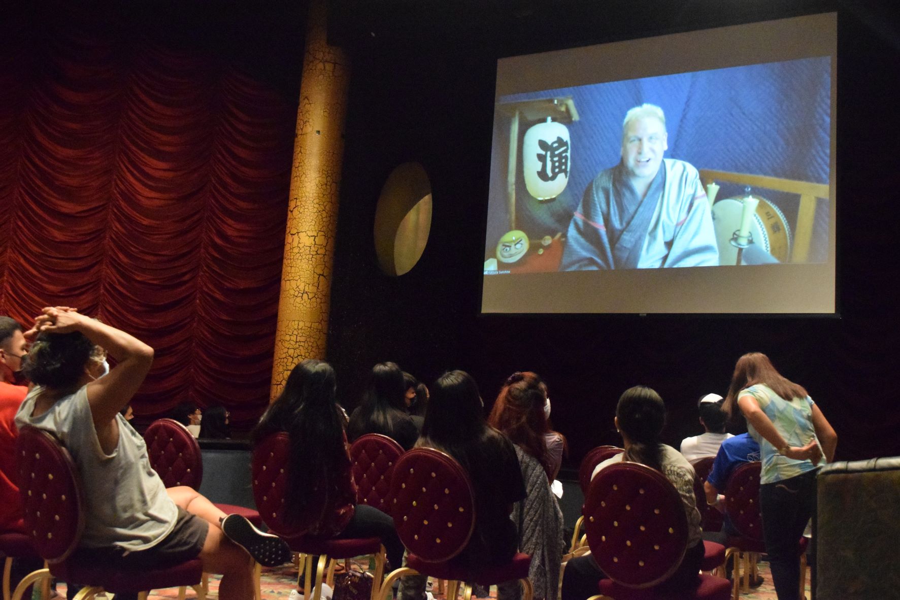 Saipan high school students and their parents watch Katsura Sunshine perform Rakugo on screen at the Hyatt Regency Saipan's Ballroom on Saturday.