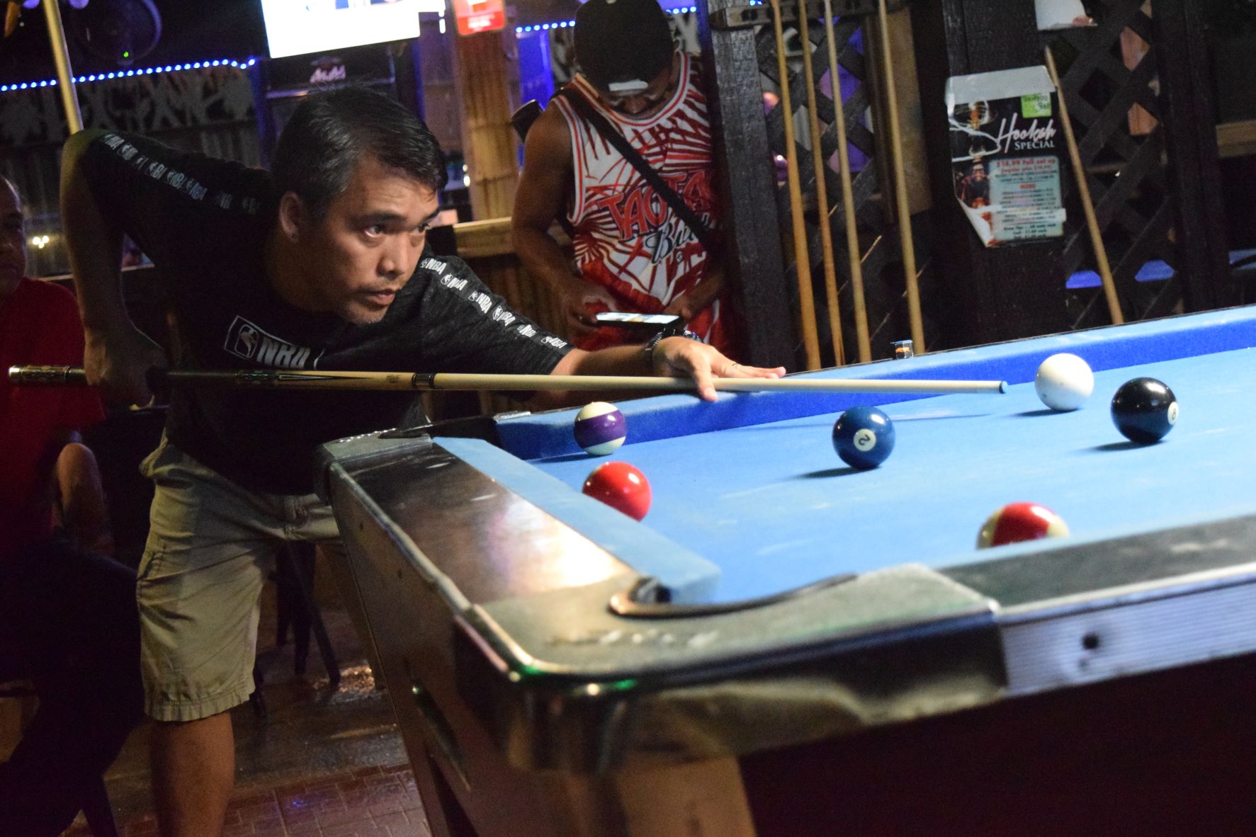 IT&E Destroyers’ Ray Pinangay sets the cue ball during  a Tuesday Division semi-final match of the Saipan Billiards Association's Budweiser Open 8-Ball League at Bamboo Club 88 on Tuesday night.
