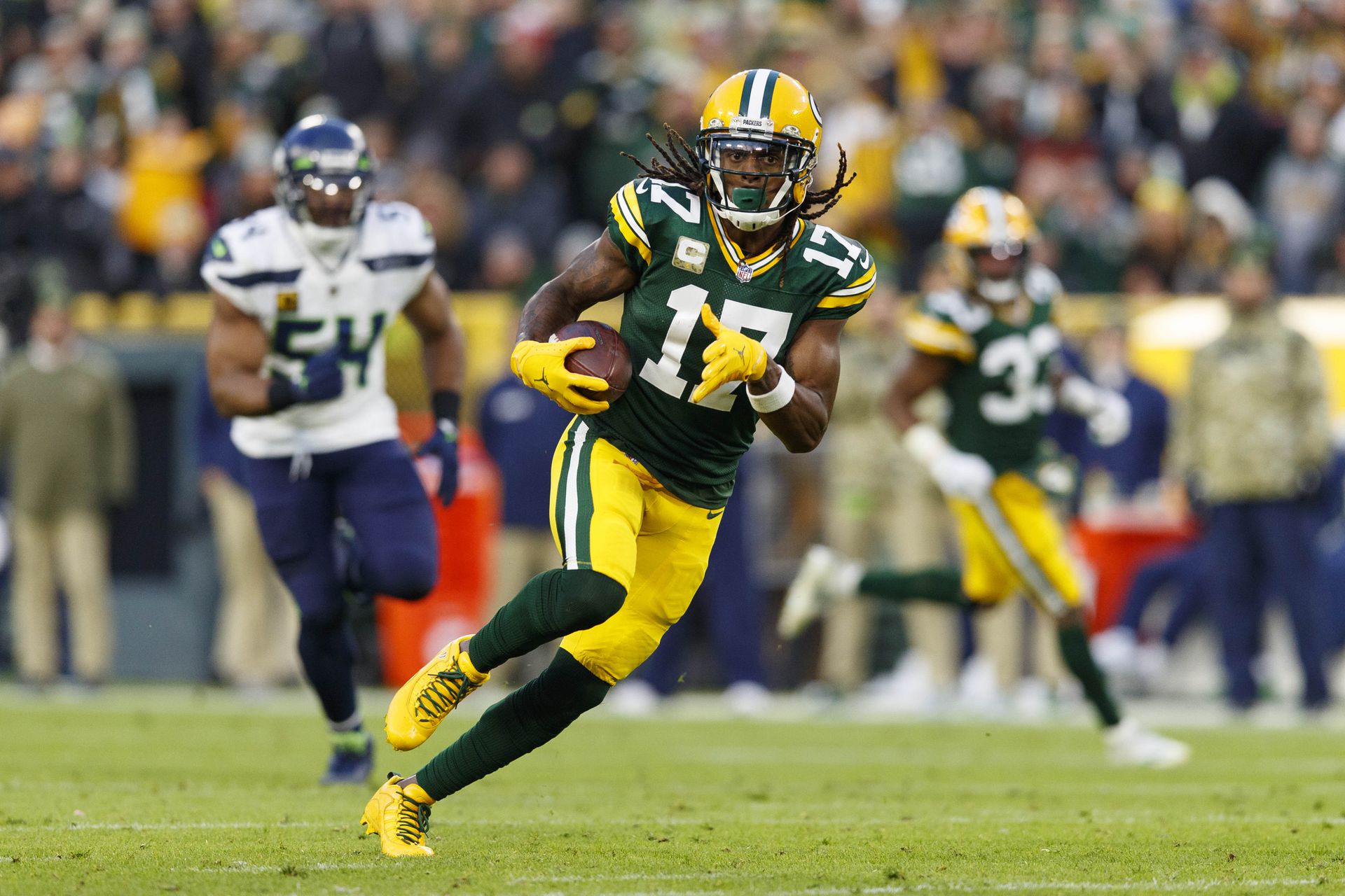 Green Bay Packers wide receiver Davante Adams (17) rushes with the ball after catching a pass during the second quarter against the Seattle Seahawks at Lambeau Field in Green Bay, Wisconsin on Nov. 14, 2021.