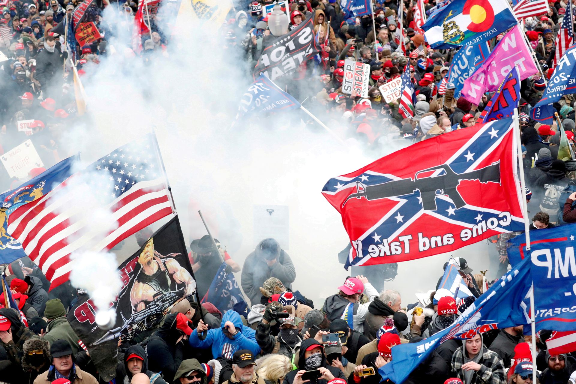 Tear gas is released into a crowd of protesters, with one wielding a Confederate battle flag that reads "Come and Take It," during clashes with Capitol police at a rally to contest the certification of the 2020 U.S. presidential election results by the U.S. Congress, at the U.S. Capitol in Washington, D.C., Jan. 6, 2021.
