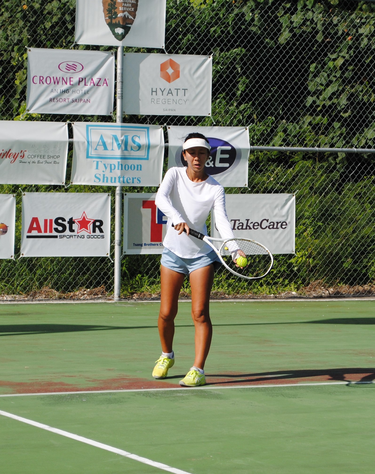 Yuko Kumada sets up for the serve during the Women's Double 4 championship match of the 11th Tan Holdings Tennis Classic at the American Memorial Park tennis court on Saturday.