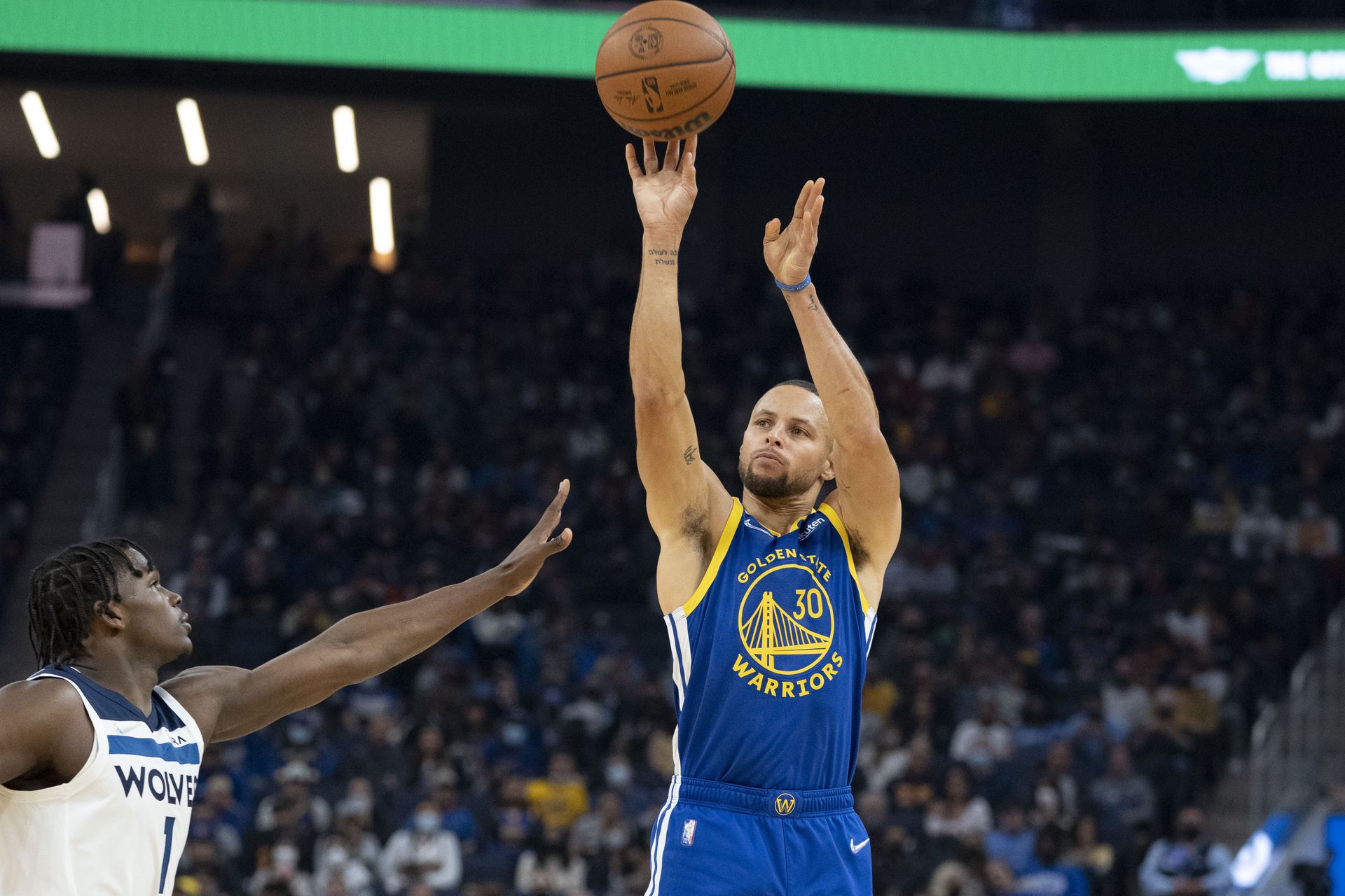 Golden State Warriors guard Stephen Curry (30) shoots the basketball against Minnesota Timberwolves forward Anthony Edwards (1) during the first quarter at Chase Center in San Francisco, California on  Nov. 10, 2021.