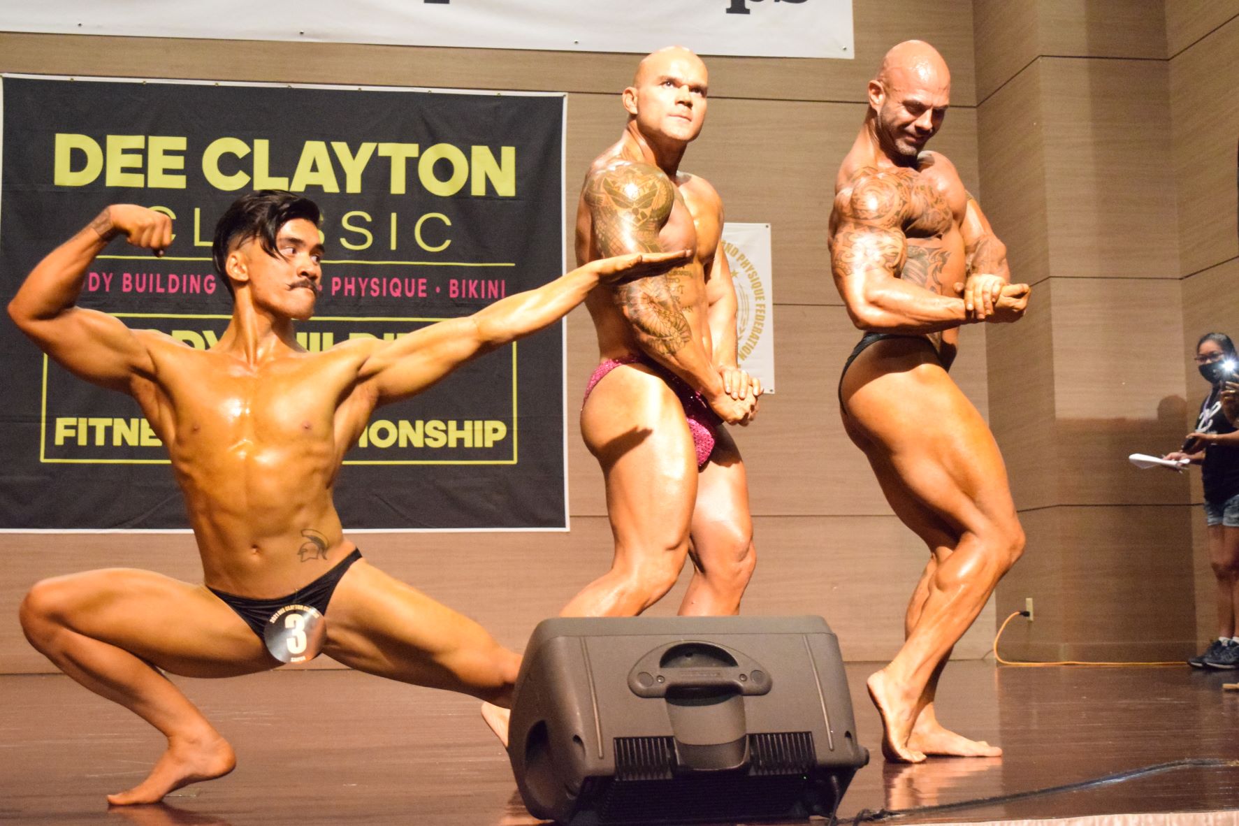 From left, Lorenzo Sanchez, Stanley Iakopo and Derek Cutting  pose during the 2021 Dee Clayton Classic Bodybuilding competition in the Taga Hall of Saipan World Resort on Saturday.