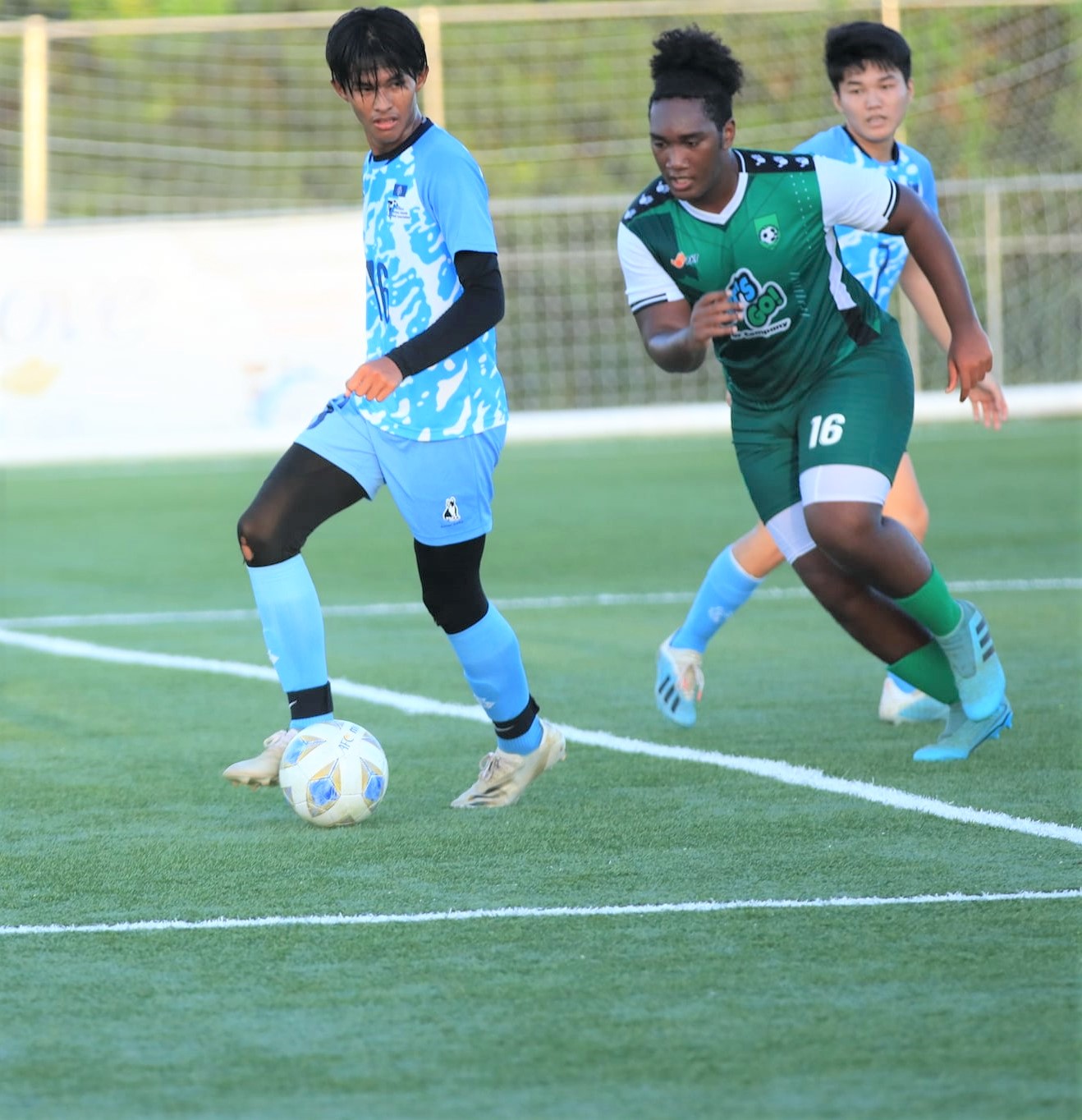 NMI U18's Markus Toves sets up the play as a defender closes in during a Marianas Soccer League game at the NMI Soccer Training Center.