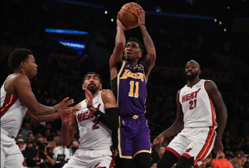 Los Angeles Lakers guard Malik Monk (11) controls the ball against Miami Heat guard Gabe Vincent (2) during the second half at Staples Center in Los Angeles, California, Nov. 10, 2021.