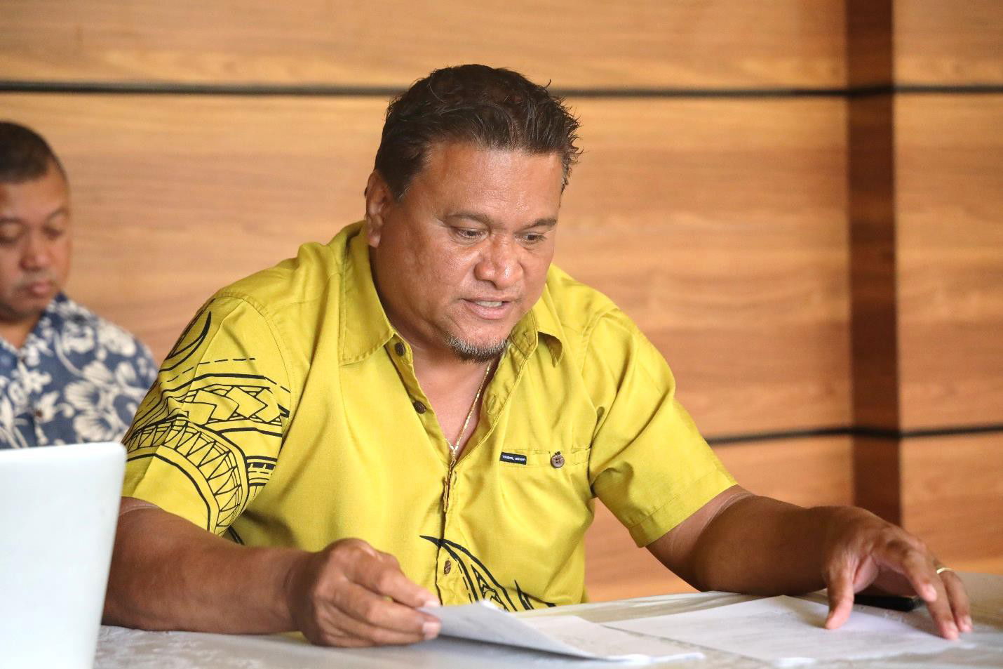 FSM Sen. Ferny Perman reviews his notes as he seeks  more details about the airport renovation projects in Ta, Woleai, and Onoun.