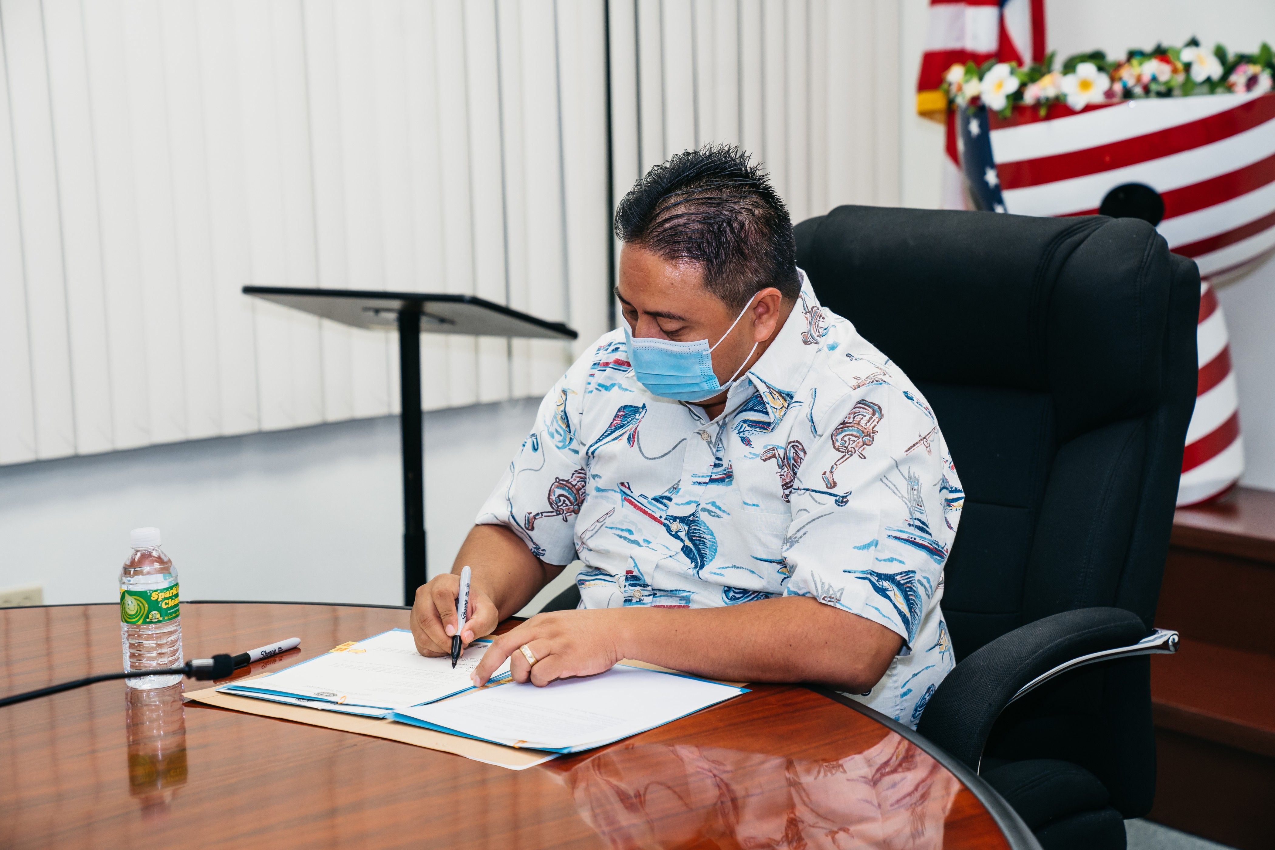 Gov. Ralph DLG Torres signs House Bill 22-2 into law Wednesday in his conference room at the administration building on Capital Hill.