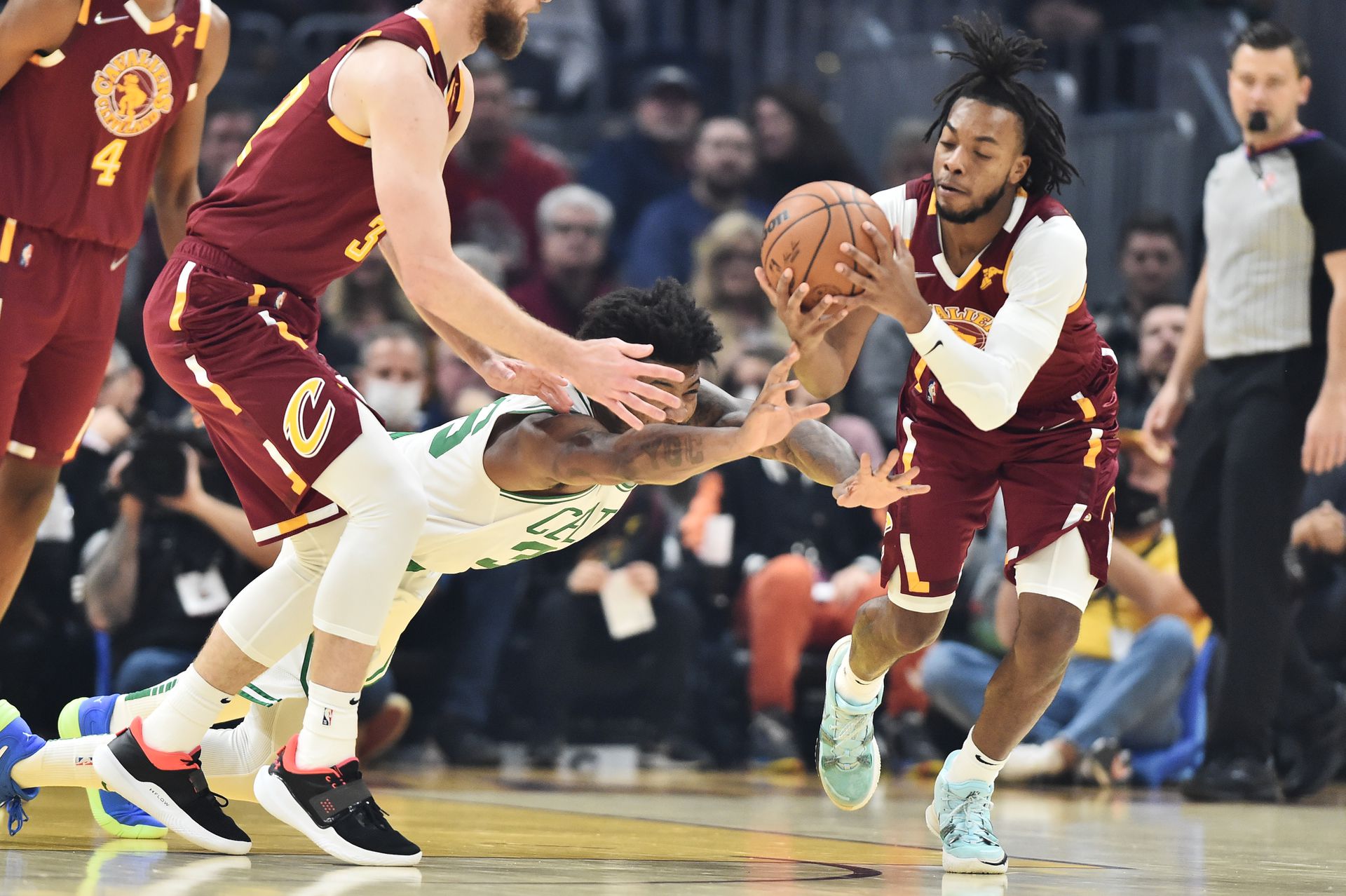 Boston Celtics guard Marcus Smart (36) and Cleveland Cavaliers guard Darius Garland (10) go for a loose ball during the first quarter at Rocket Mortgage FieldHouse in Cleveland, Ohio on Nov. 13, 2021.
