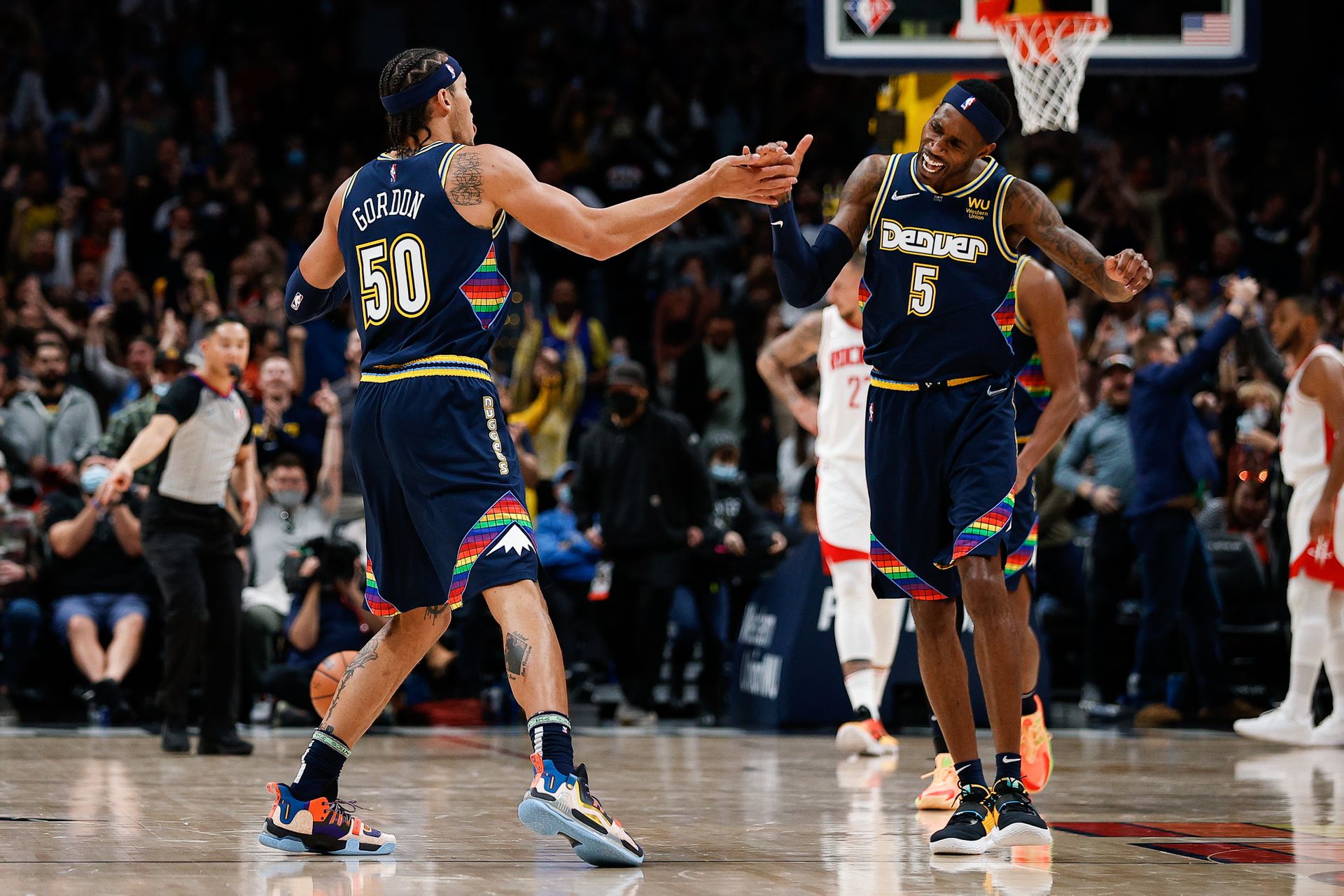 Denver Nuggets forward Will Barton (5) celebrates with forward Aaron Gordon (50) after a play in the fourth quarter against the Houston Rockets at Ball Arena in Denver, Colorado on Nov. 6, 2021.