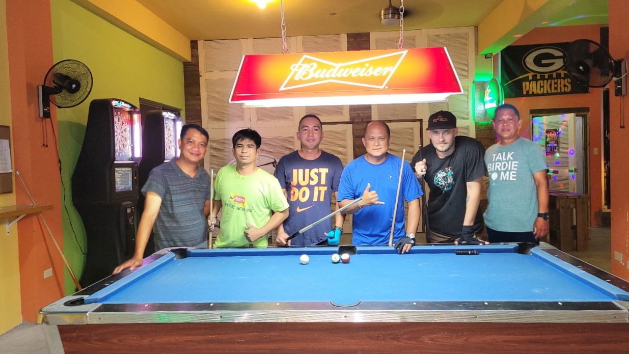 Members of team Last Shot Eagle's Eye pose for a photo after claiming the Thursday Division championship  of the SBA Budweiser Open 8-Ball League at the Last Shot Bar on Thursday.