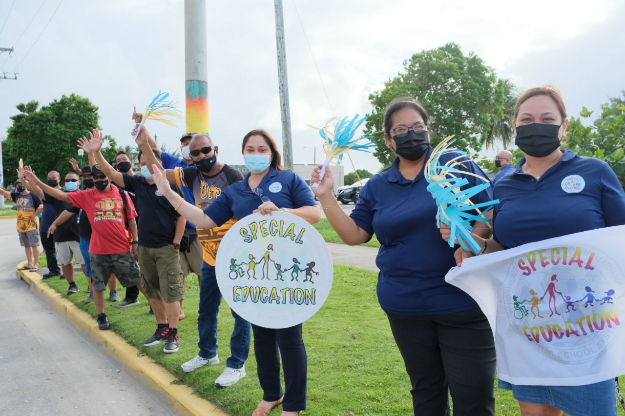 The Special Education Program led by Director Donna Flores, Data and Compliance Program Manager Nora Fujihira and Data Specialist Lucille Deleon Guerrero participate in the road side waving activity.