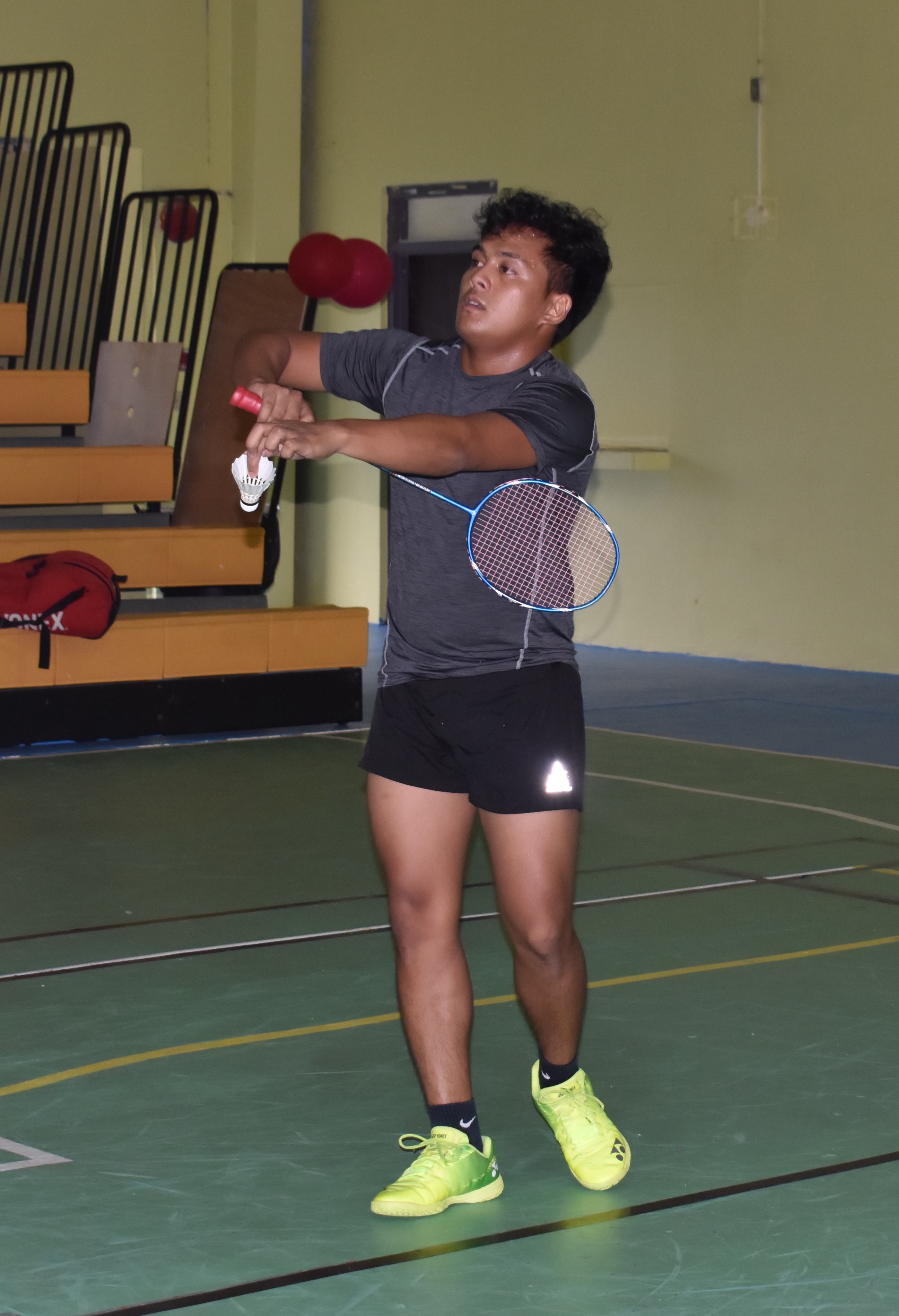 Joseph Torres serves against Andreau Galvez — not pictured — in their singles game in the TakeCare Badminton Open at the Gilbert C. Ada Gymnasium in October. Torres will play in the inaugural NMI Badminton National Championships this weekend at the TSL Sports Complex.