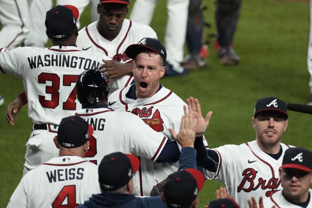 Atlanta Braves relief pitcher Will Smith, center, celebrates their win in Game 4 of baseball's World Series between the Houston Astros and the Atlanta Braves Saturday in Atlanta. The Braves won 3-2, to lead the series 3-1 games. 