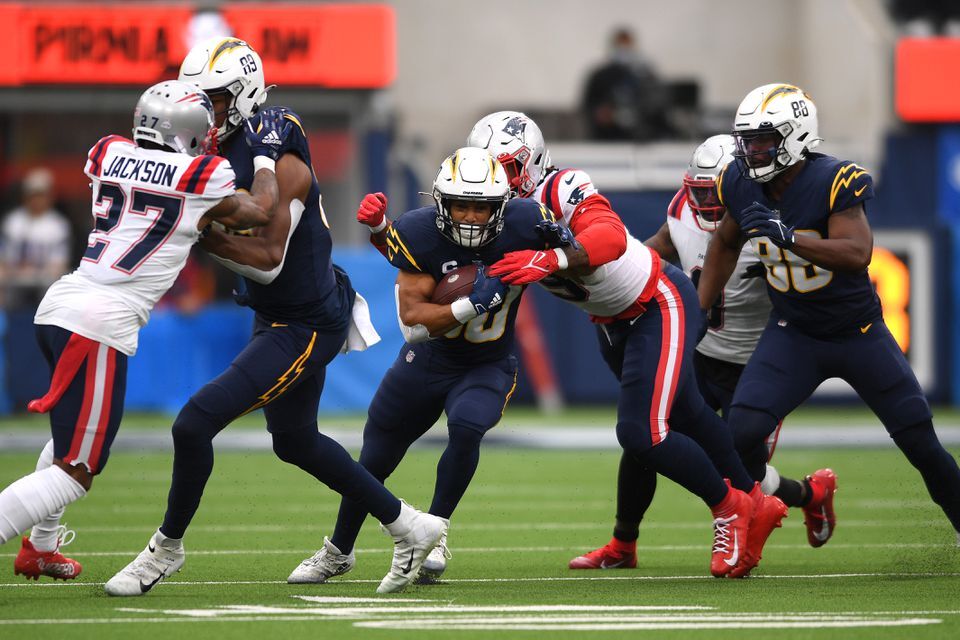 Los Angeles Chargers running back Austin Ekeler (30) is tackled by New England Patriots linebacker Donta’a Hightower (54) during the first quarter at SoFi Stadium in Inglewood, California on Oct. 31, 2021.
