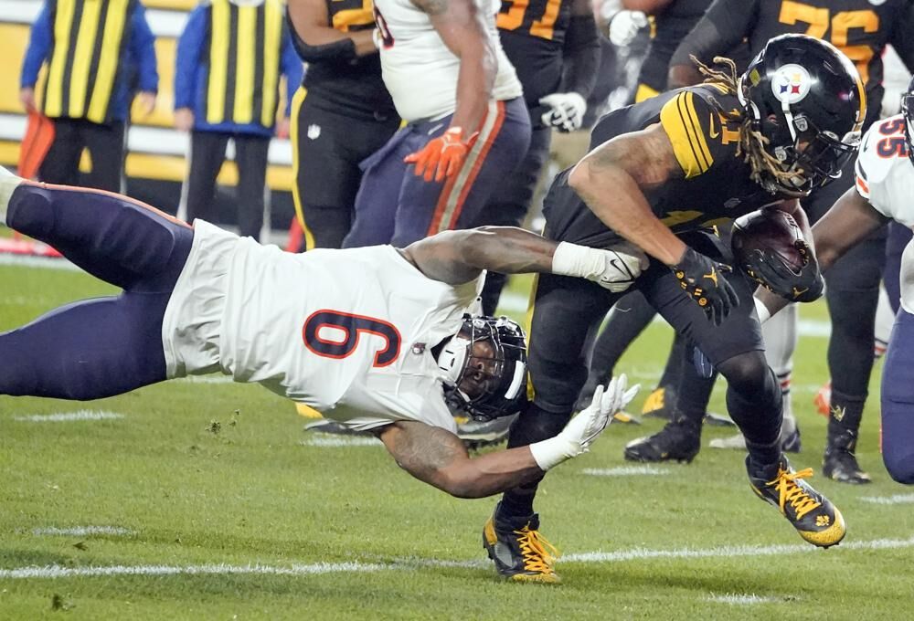 Pittsburgh Steelers wide receiver Chase Claypool, right, tries to get away from Chicago Bears linebacker Danny Trevathan (6) after making a catch during the first half of an NFL football game, Monday, in Pittsburgh.