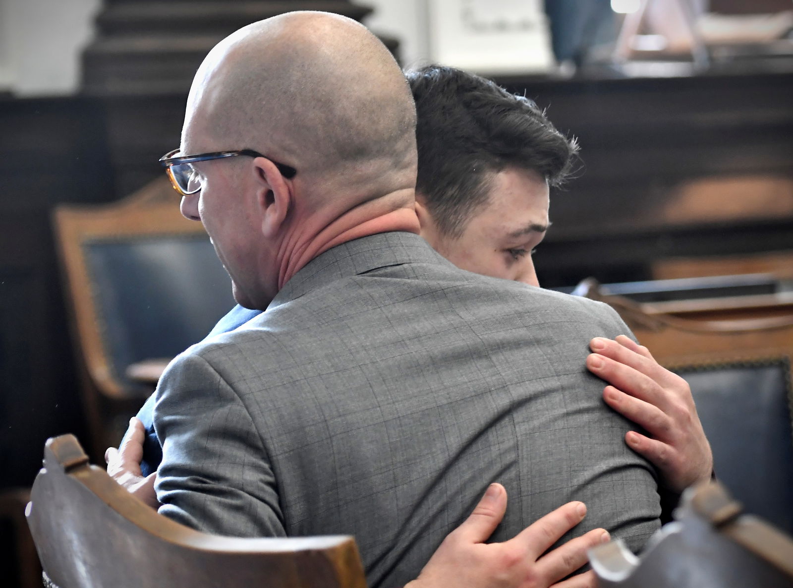 Kyle Rittenhouse hugs one of his attorneys, Corey Chirafisi, as he reacts to the verdict during his trial at the Kenosha County Courthouse in Kenosha, Wisconsin, Nov. 19, 2021.