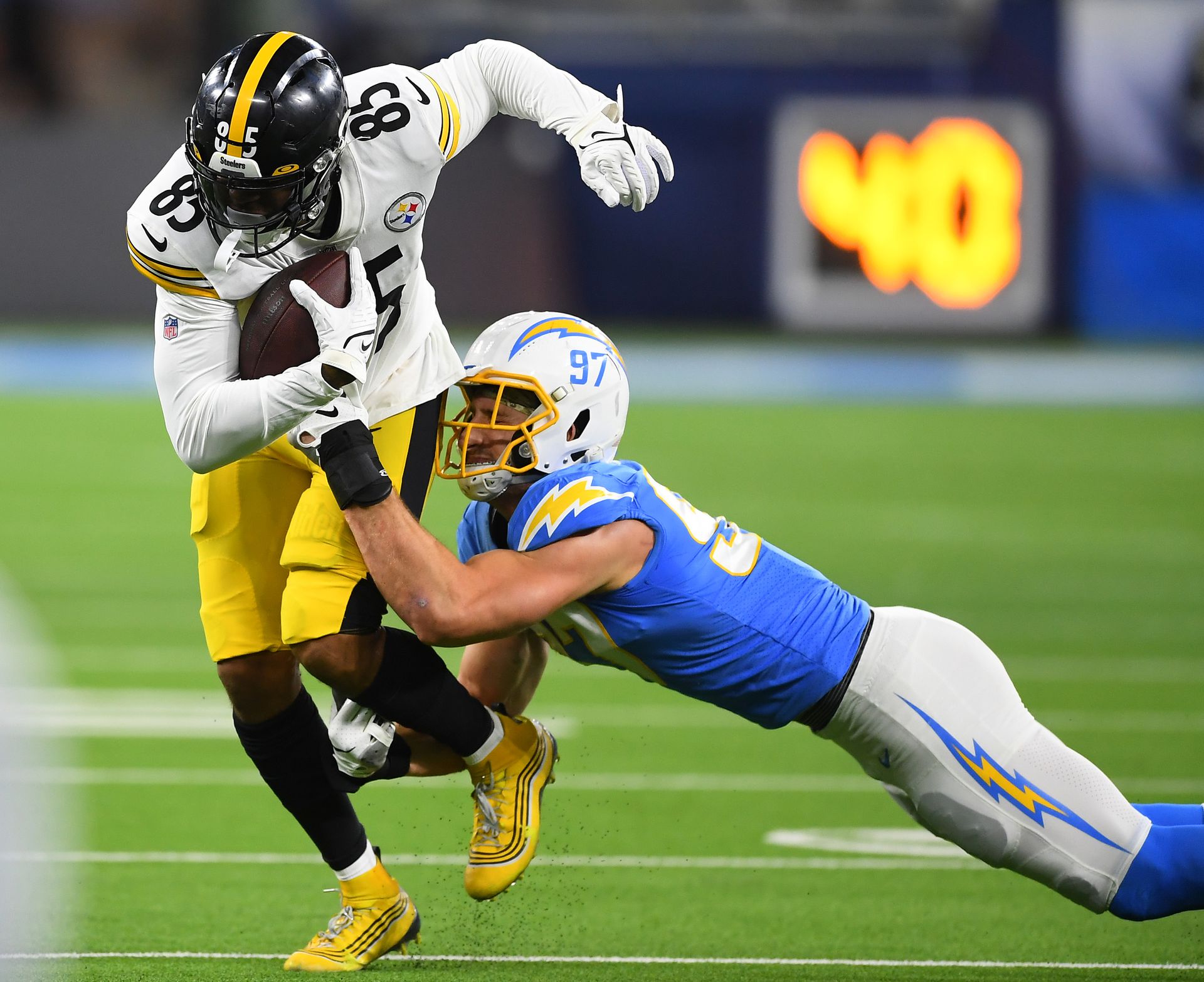 Pittsburgh Steelers tight end Eric Ebron (85) is stopped by Los Angeles Chargers defensive end Joey Bosa (97) after a pass play for a first down in the second half the game at SoFi Stadium in Inglewood, California on Nov 21, 2021.
