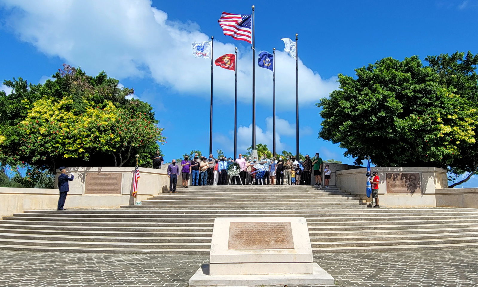 Justin Xu Poon, SrA, far left, plays the Taps while CNMI officials, veterans, military officials, their families and other community members look on at the Court of Honor of American Memorial Park on Thursday, Veterans Day.