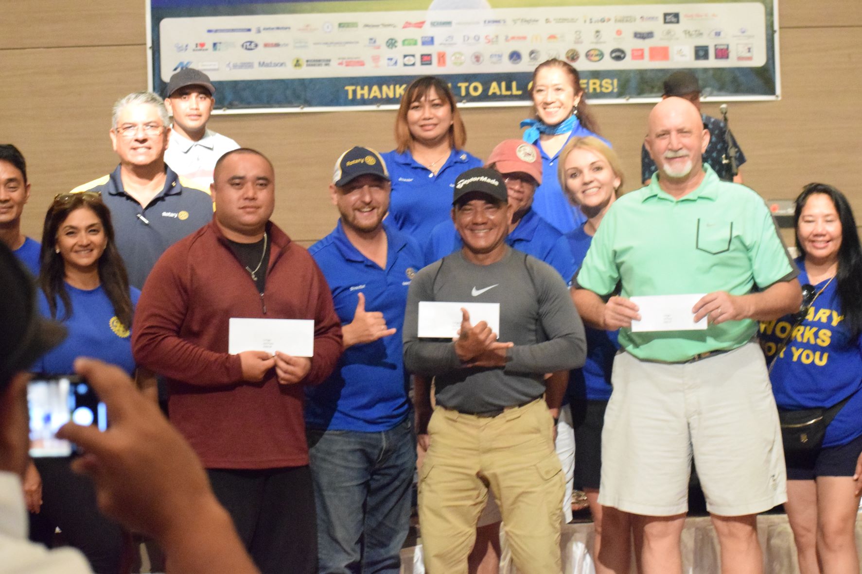 C Flight winner Bart Jackson, second right, second placer Dave Jones, third left, and third placer Chris Deleon Guerrero, center, pose for a photo with the Saipan Rotarians during the awards banquet for the Goodwill Golf Classic at Saipan World Resort on Saturday.