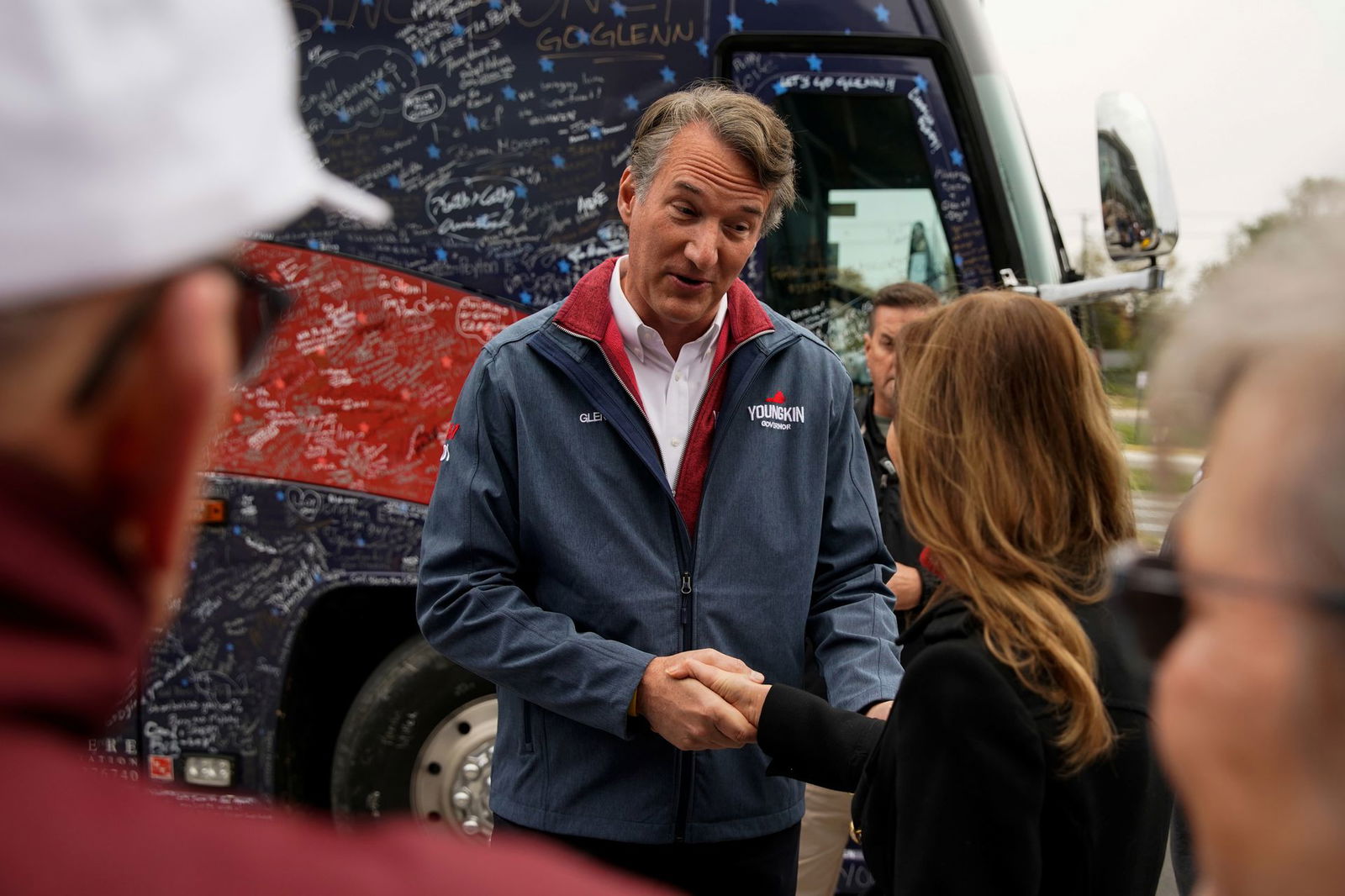 Virginia Republican gubernatorial nominee Glenn Youngkin talks to people outside a polling place on the Election Day at Rocky Run Middle School in Chantilly, Virginia, Nov. 2, 2021. 