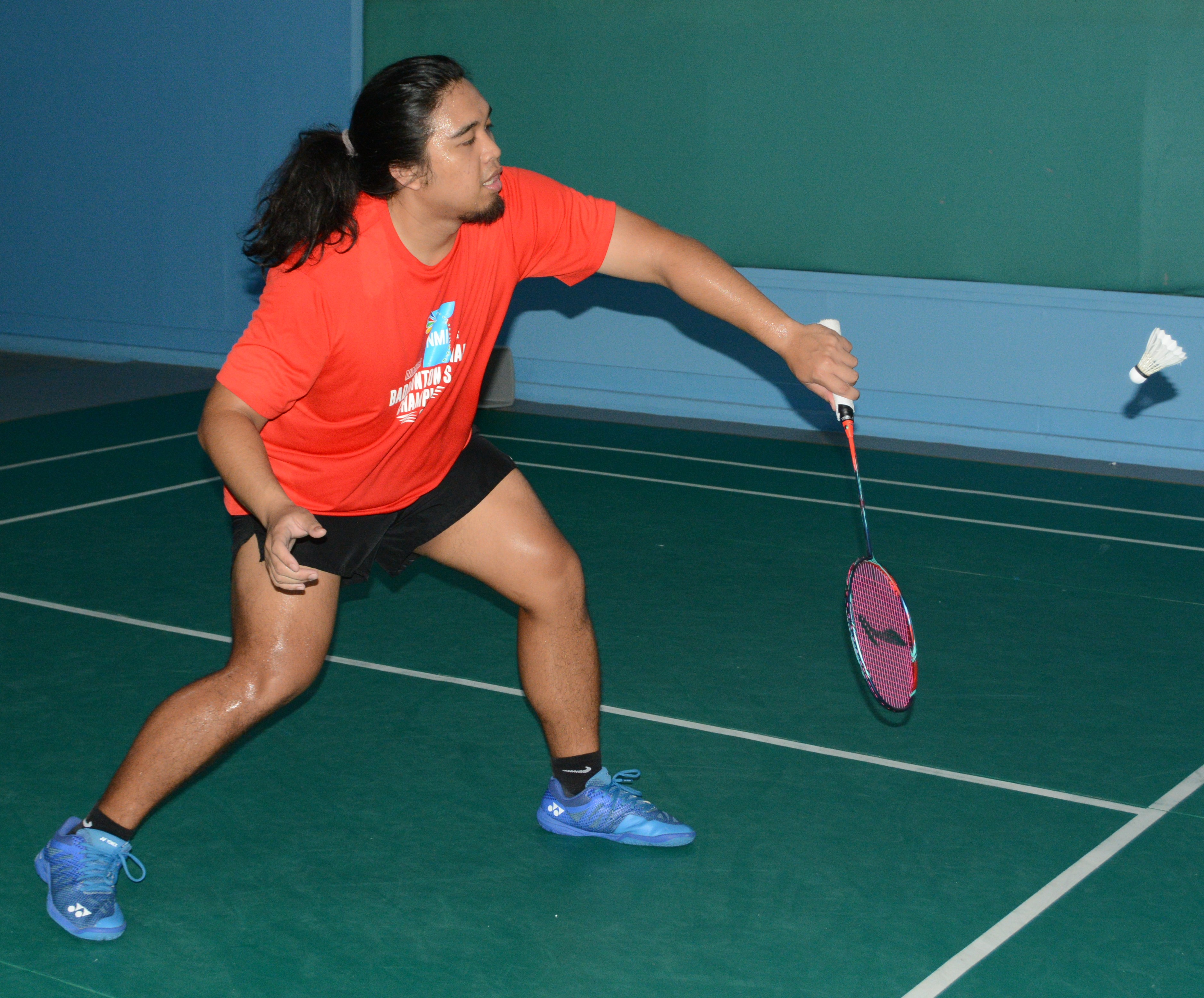 Ezekiel Macario attempts a backhand return during a match Friday at the TSL Sports Complex.