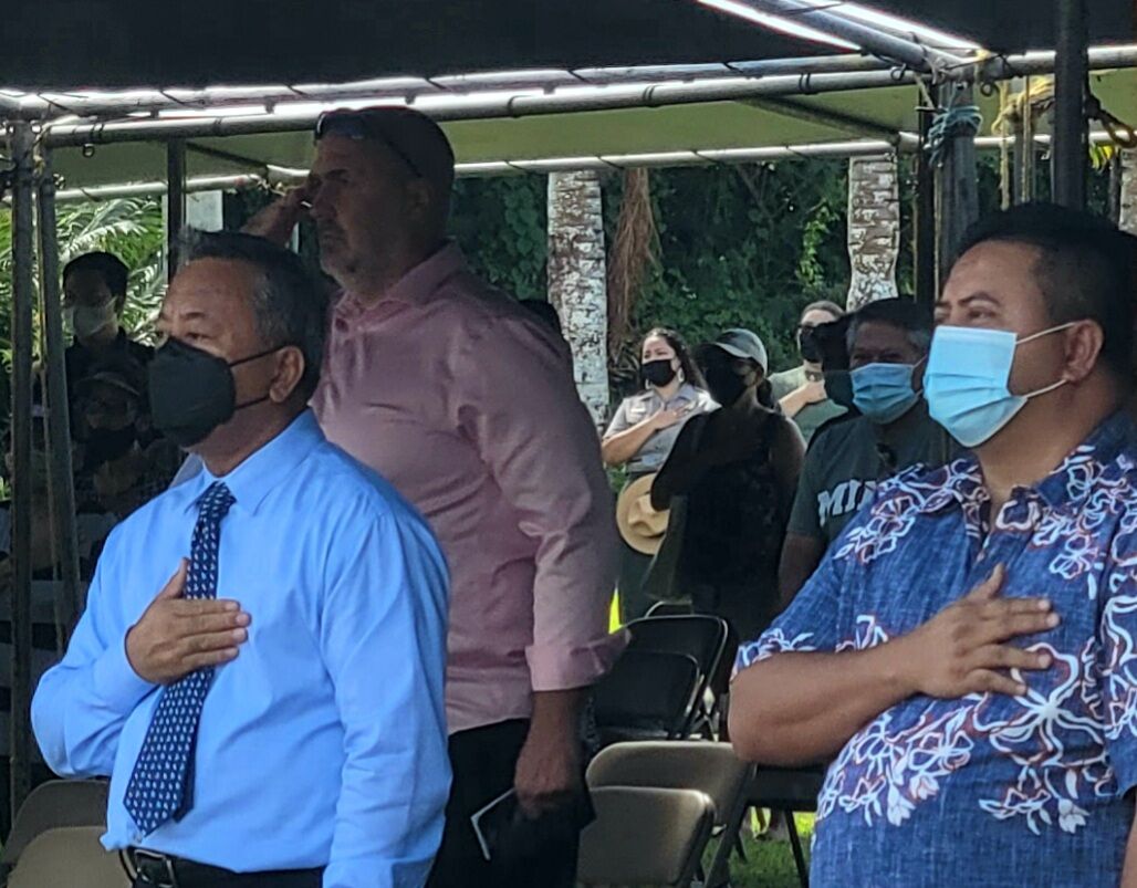 Civilian Aide to the Secretary of the Army Michael S. Sablan, left, and Gov. Ralph DLG Torres, right, sing the national anthem.