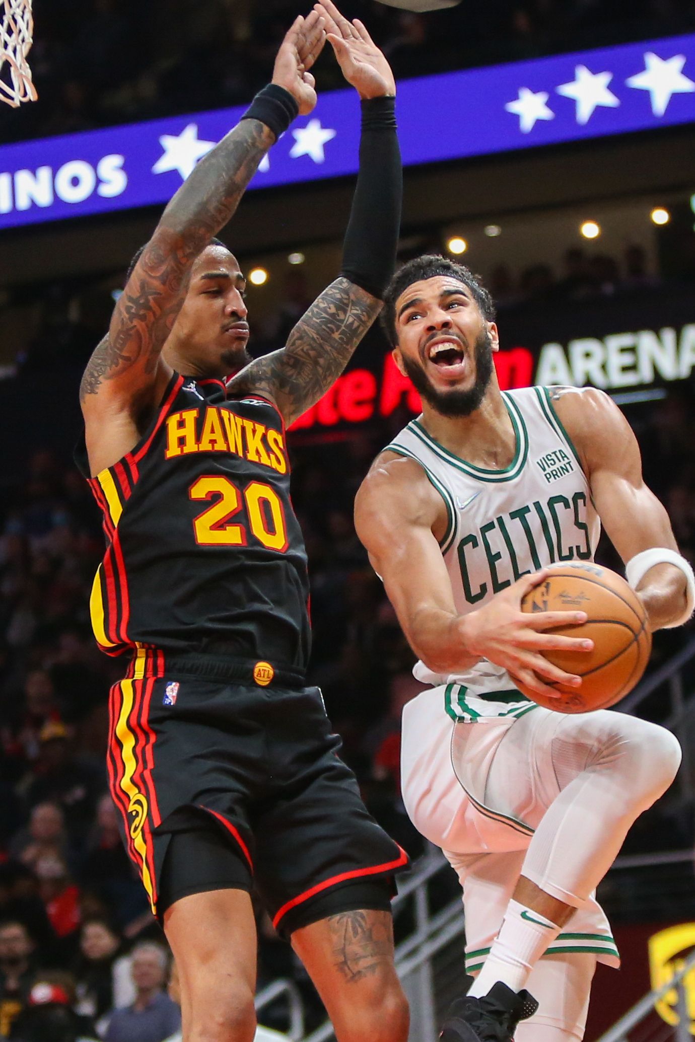 Boston Celtics forward Jayson Tatum (0) shoots past Atlanta Hawks forward John Collins (20) in the second half at State Farm Arena in Atlanta, Georgia on Nov. 17, 2021.