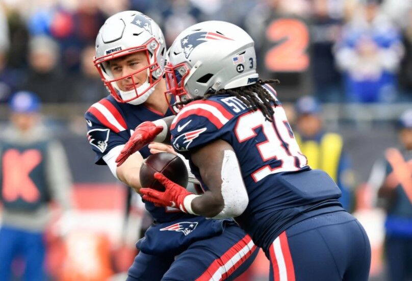New England Patriots quarterback Mac Jones (10) hands the ball off to running back Rhamondre Stevenson (38) during the first half of a game against the Cleveland Browns at Gillette Stadium in Foxborough, Massachusetts  on Nov. 14, 2021.