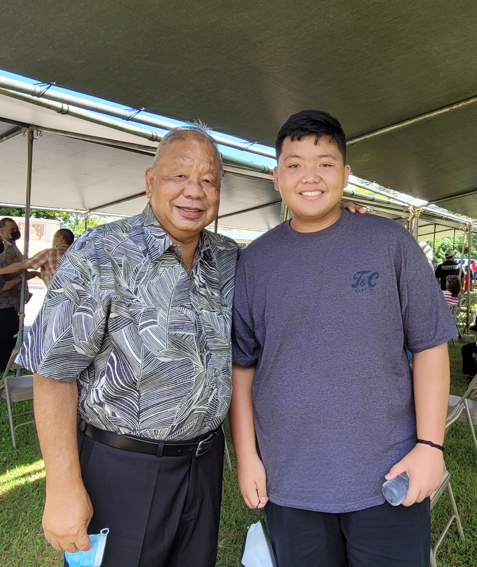 Saipan Mayor David M. Apatang, a veteran, with his grandson Charles Pablo Cepeda.
