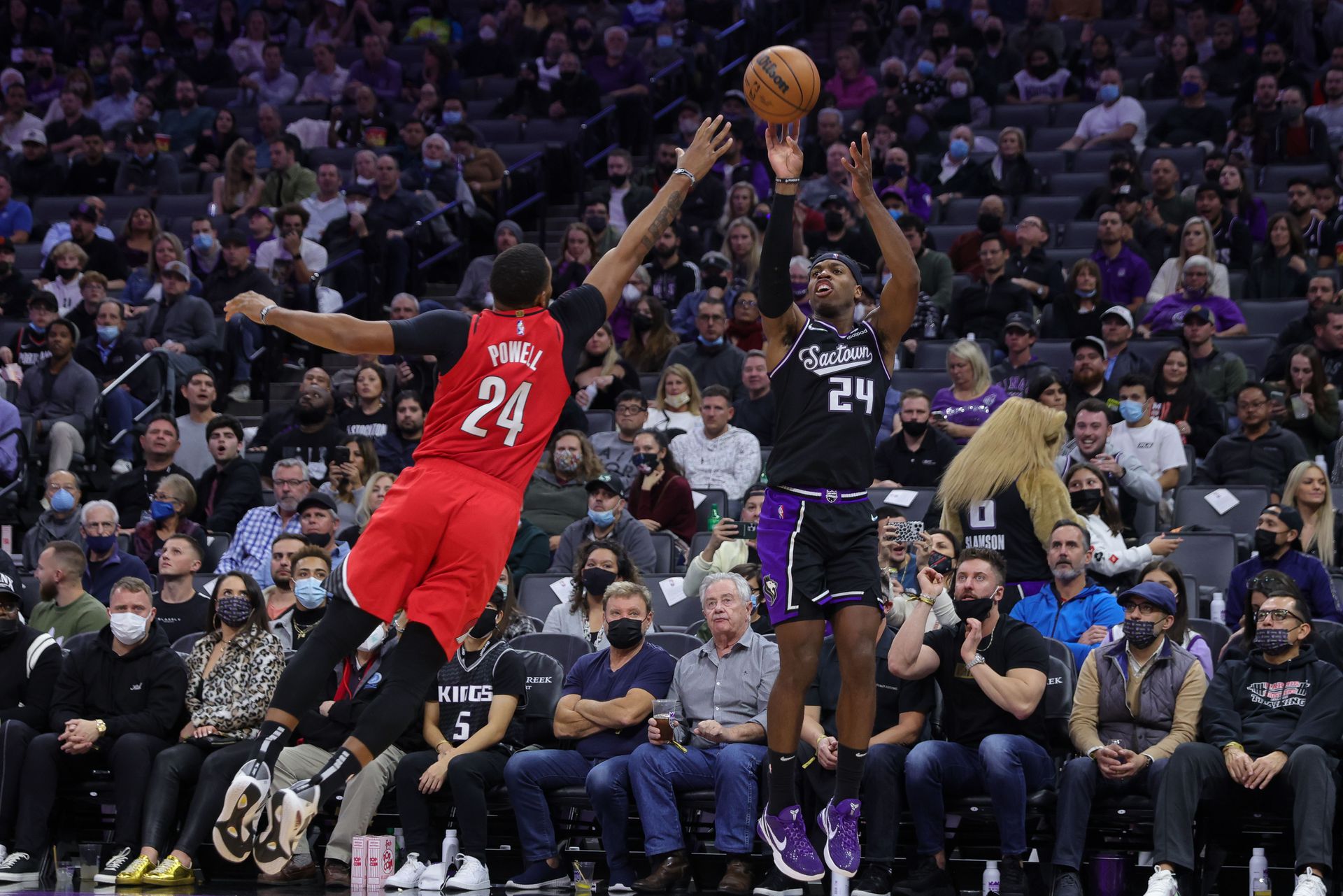 Sacramento Kings guard Buddy Hield (24) shoots the ball over Portland Trail Blazers forward Norman Powell (24) during the fourth quarter at Golden 1 Center in Sacramento, California on Nov. 24, 2021.