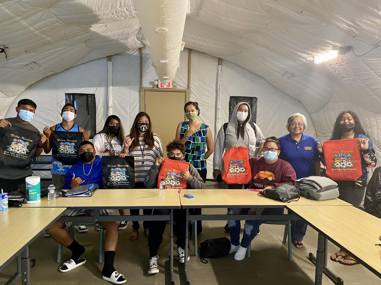 Students of Da’ok Academy in Koblerville, Saipan, learn about tourism and the Marianas Visitors Authority on Oct. 28, 2021.   Pictured are students, Marianas Tourism Education Council acting Chairwoman Vicky Benavente, second from left, and other MTEC and MVA representatives.