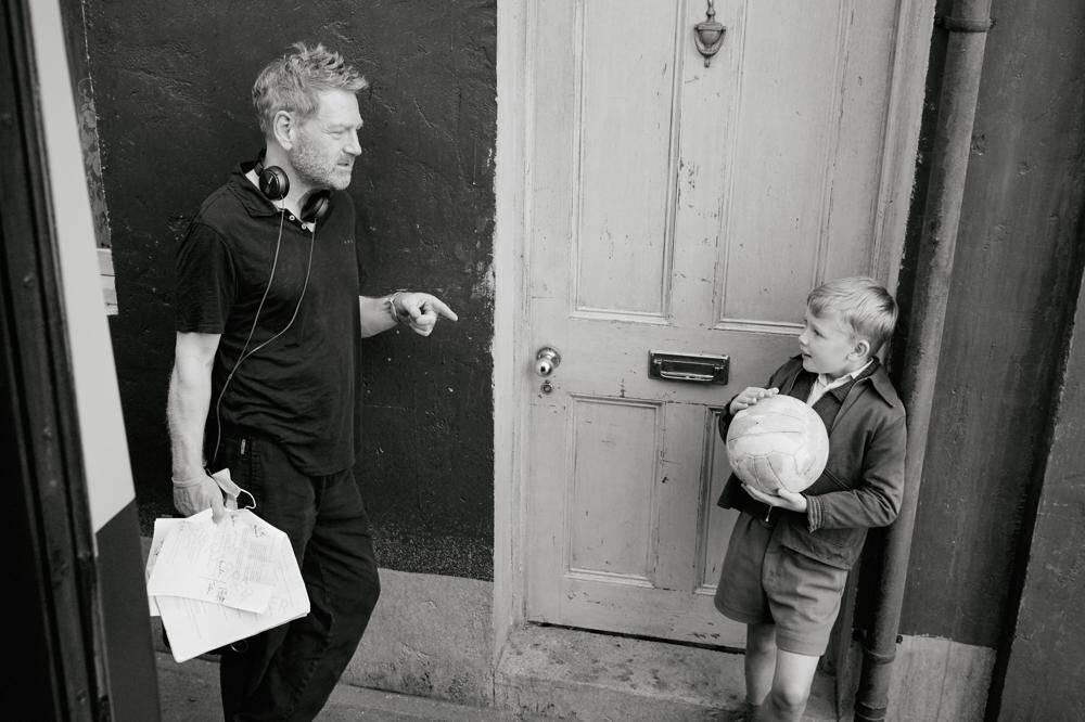 Director Kenneth Branagh, left, appears with actor Jude Hill on the set of "Belfast."