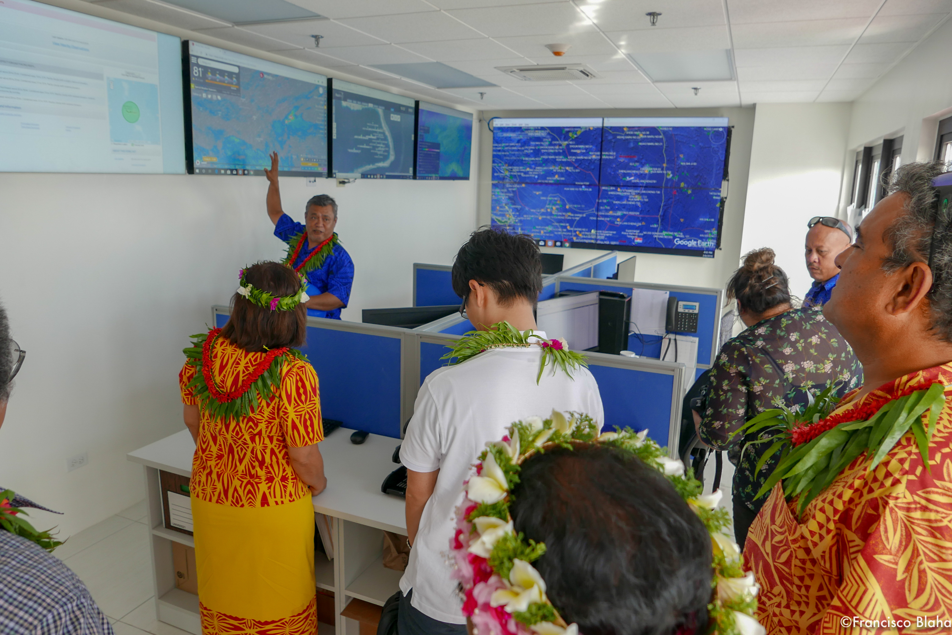 Marshall Islands Marine Resources Authority Director Glen Joseph, top left,  gives visitors to MIMRA's recently opened headquarters building a look at monitoring, control and surveillance tools the fisheries authority uses to managed the tuna fisheries.