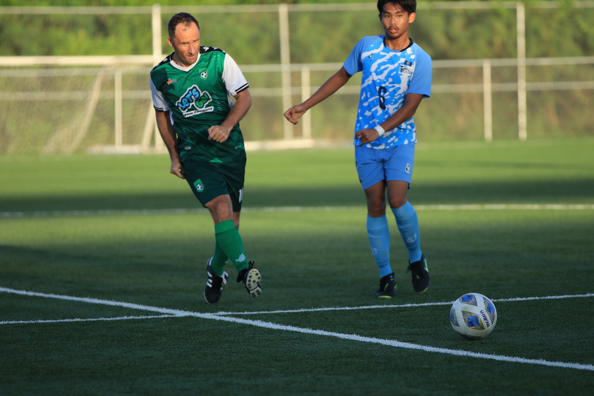 Tan Holdings’ Martin Jambor attempts a pass as a defender closes in during an MSL Cup game at the NMI Soccer Training Center.