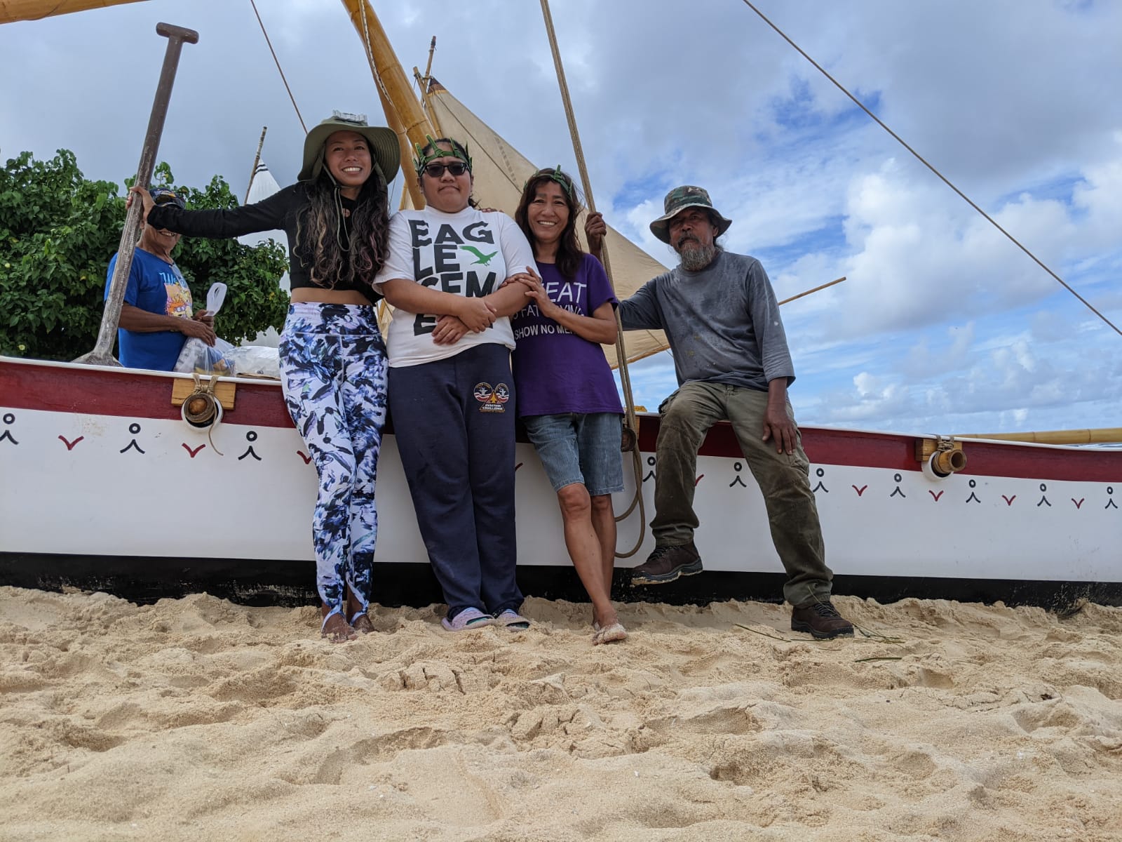 Marjorie Daria poses with her family at Tachogna Beach on the Auntie Oba canoe. From left, Marjorie, her sister Mary Loise, her mom Lourdes and father Juan Atalig.