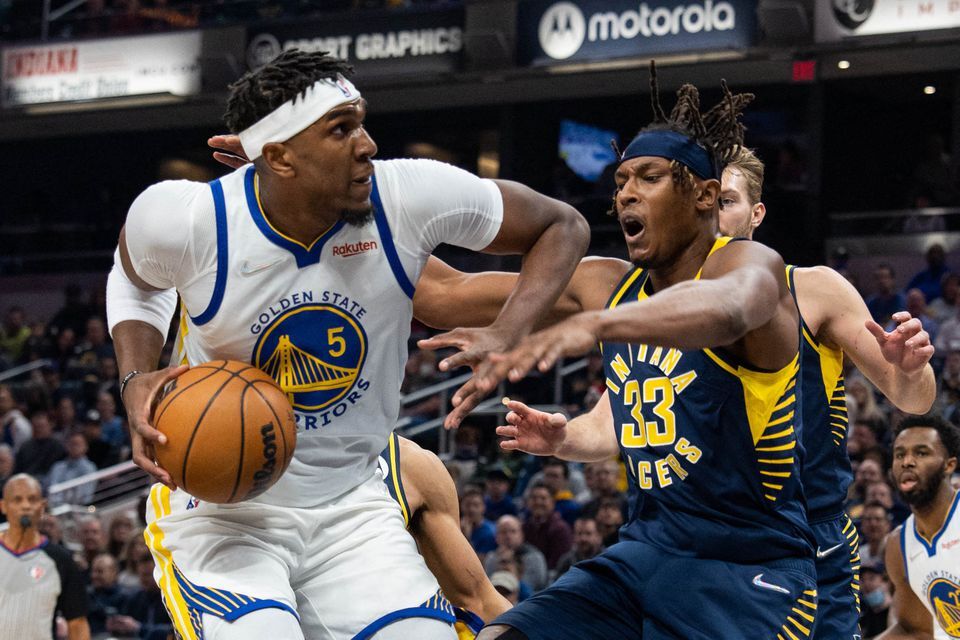 Golden State Warriors center Kevon Looney (5) shoots the ball while Indiana Pacers center Myles Turner (33) defends in the first quarter at Gainbridge Fieldhouse Indianapolis, Indiana on Dec. 13, 2021.