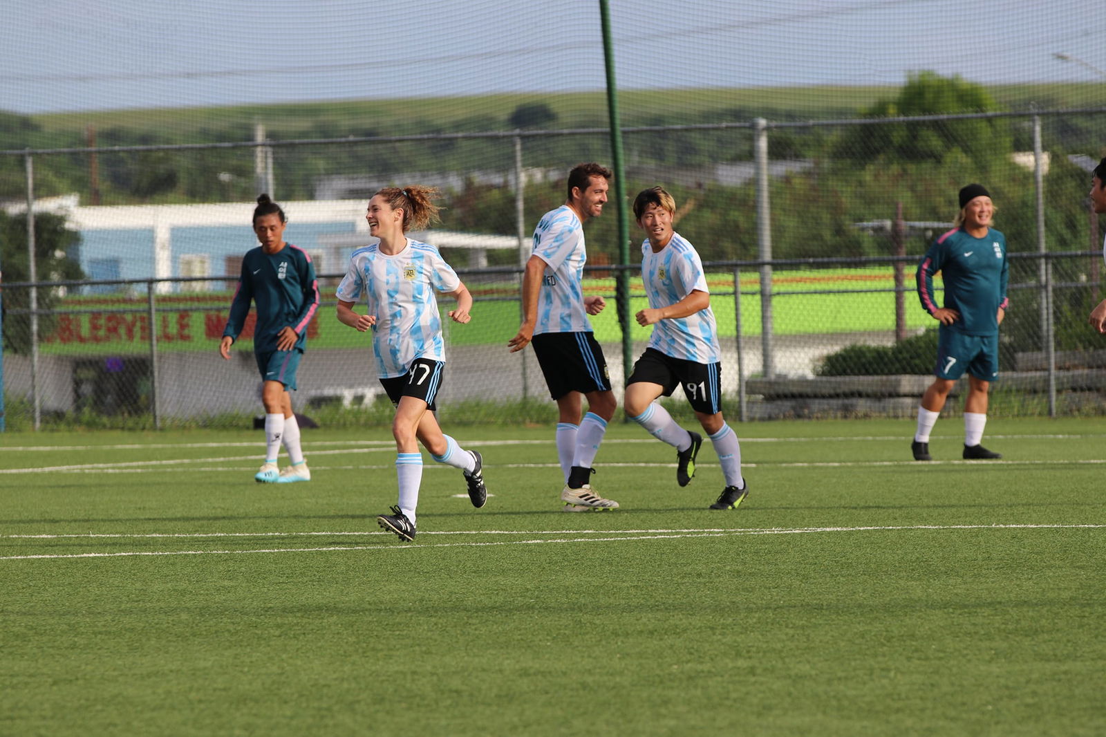 Saipan United's Lillian Muldoon and Kuu Nishimura celebrate after scoring a goal during the Hafa Adai Fun Cup title game Sunday at the NMI Soccer Training Center.