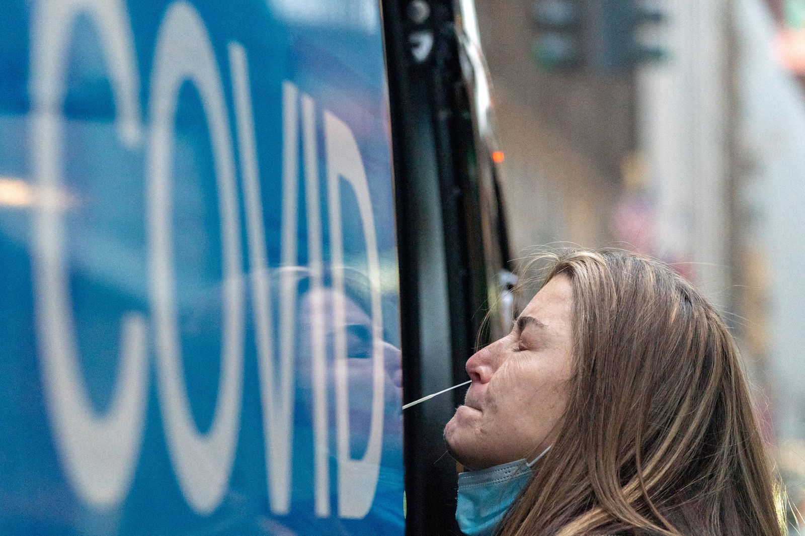 A woman takes a coronavirus disease  test at a pop-up testing site as the Omicron coronavirus variant continues to spread in Manhattan, New York City, Dec. 27, 2021.