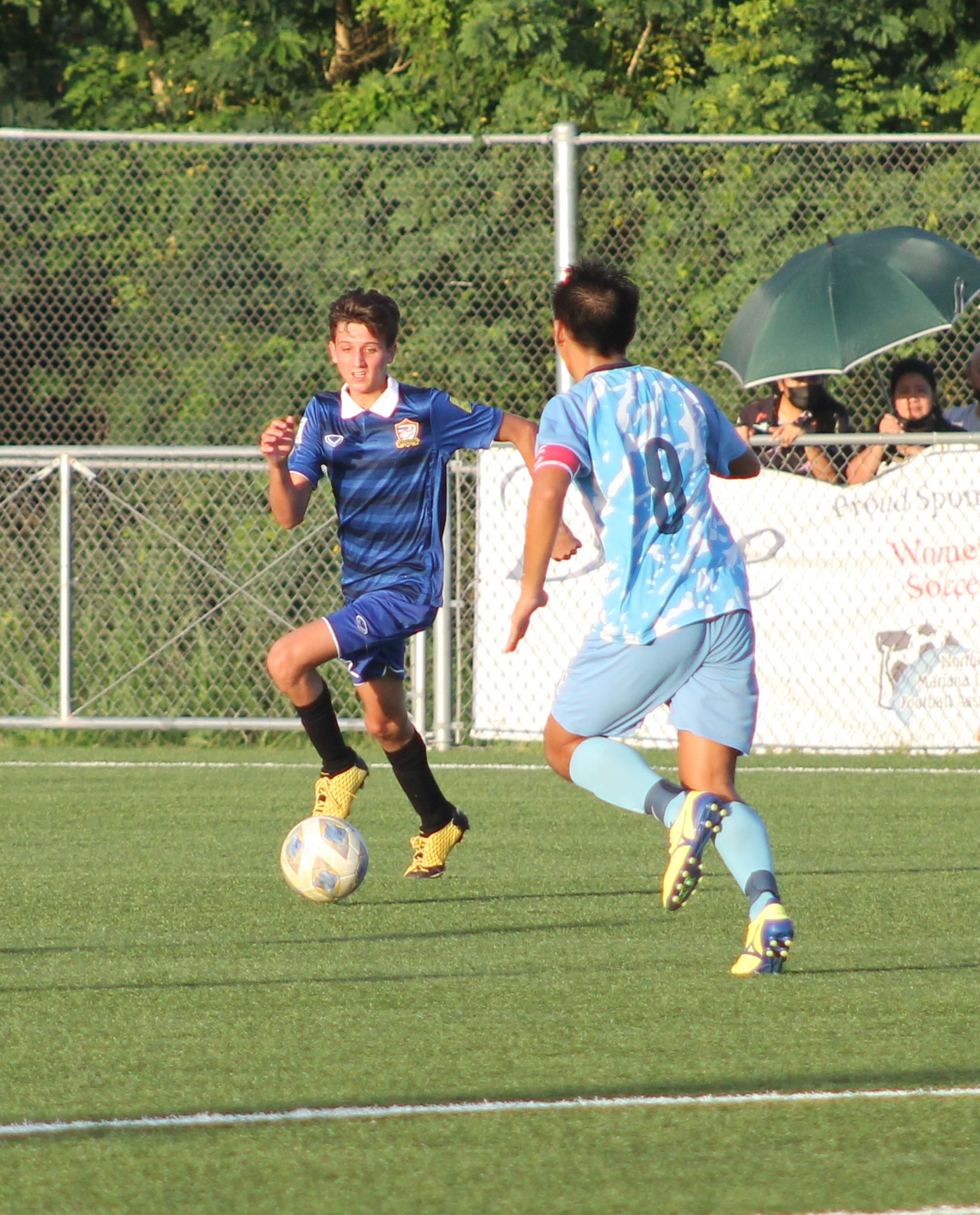 Eleven Tiger's Paramee Sriprasert pushes forward as a defender closes in.