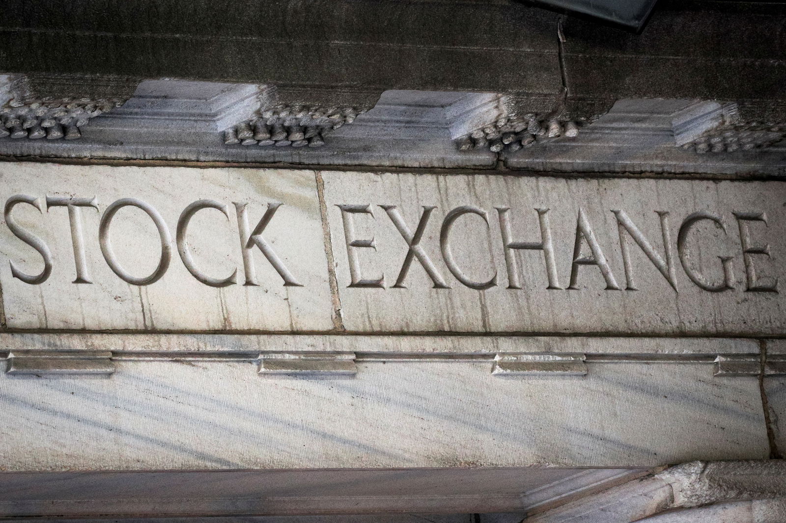 The words “Stock Exchange” are seen over an entrance to the New York Stock Exchange on Wall St. in New York City on March 29, 2021.